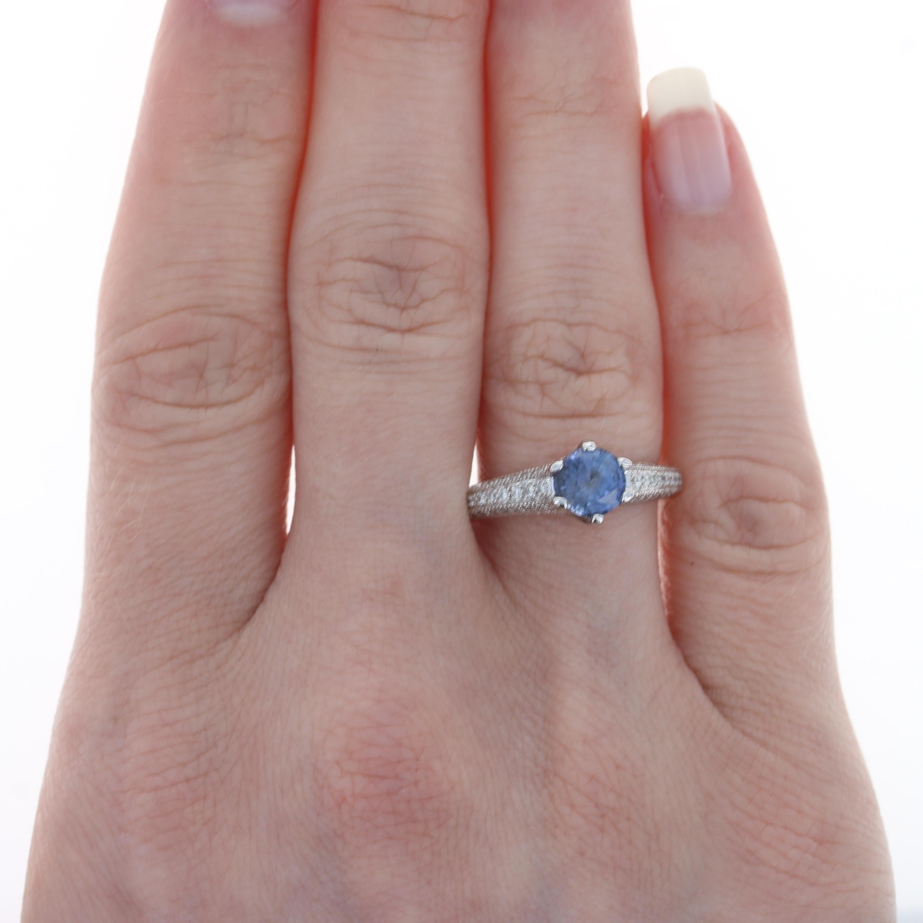 Size: 7 1/4
Sizing Fee: Down 1 size for $25 or Up 2 sizes for $30

Metal Content: 14k White Gold

Stone Information: 
Genuine Sapphire
Treatment: Heating
Carat(s): 1.07ct (weighed)
Cut: Round
Color: Purplish Blue
Diameter: 6.1mm 

Natural