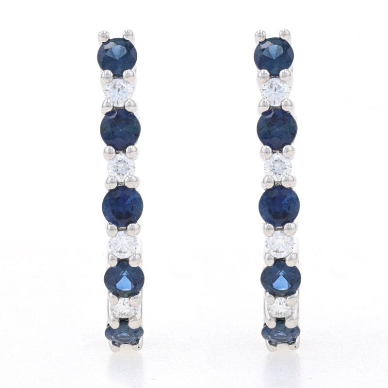 Metal Content: 14k White Gold

Stone Information
Natural Sapphires
Treatment: Heating
Carats: .90ctw
Cut: Round
Color: Blue

Natural Diamonds
Carats: .17ctw
Cut: Round Brilliant
Color: F - G
Clarity: VS2 - SI1

Total Carats: 1.07ctw

Style: J-Hook
