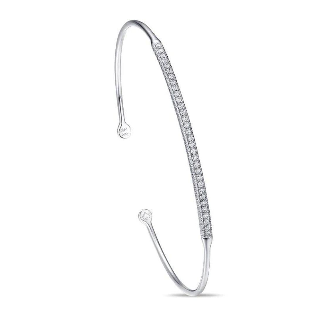 Elegant 14k white gold bangle with pave set round brilliant diamonds. Perfect to wear on its own or stacked with other bangles. Bangle contains thirty two diamonds H-I color, SI clarity, total carat weight 0.22 ctw. One size fits most. Excellent