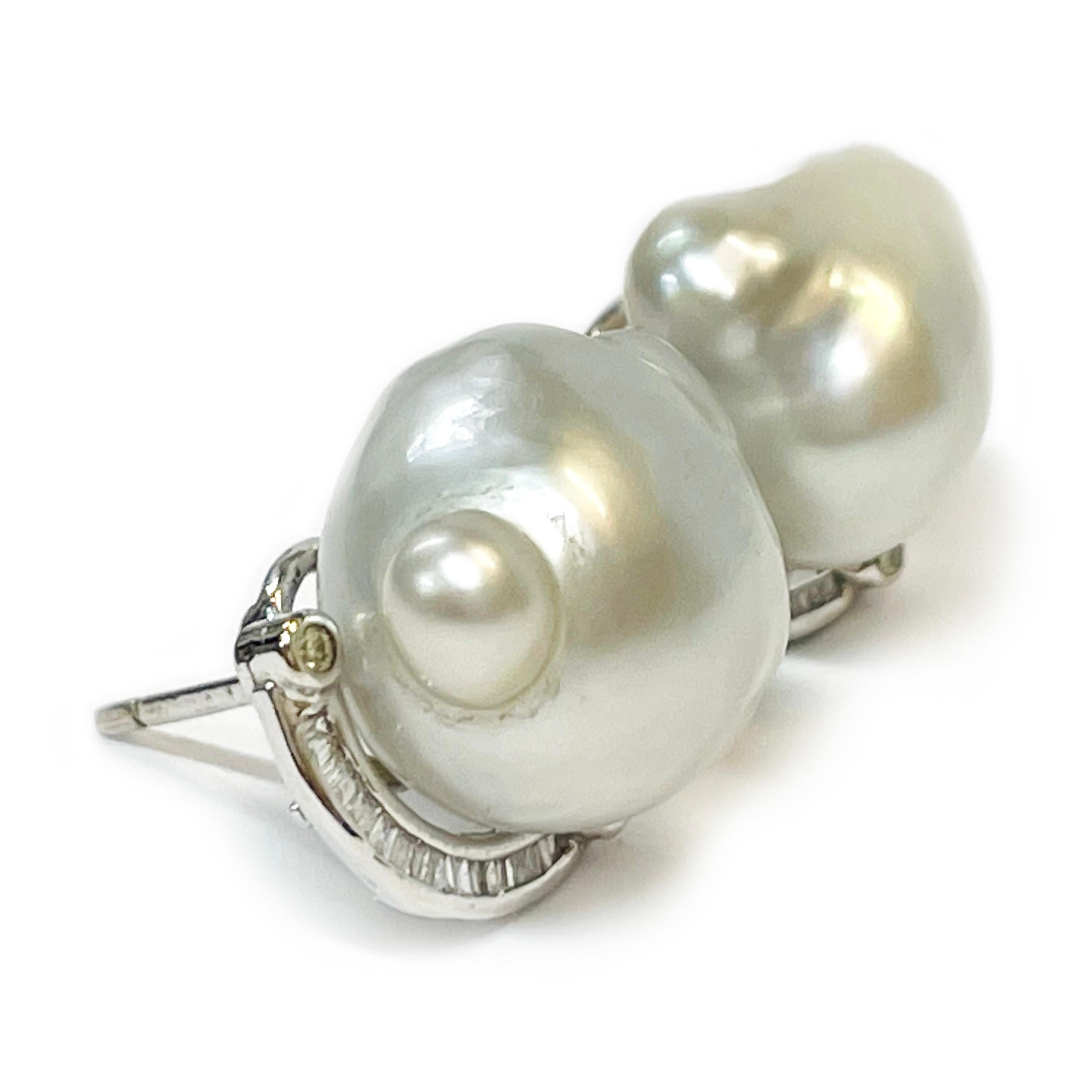 14 Karat White Gold South Sea Baroque Pearl Diamond Earrings. Each earring features a South Sea Baroque pearl and a semi-curve of channel-set baguettes and four bezel-set round diamonds. The four round diamonds measure 1.5mm each/0.015ct for a total