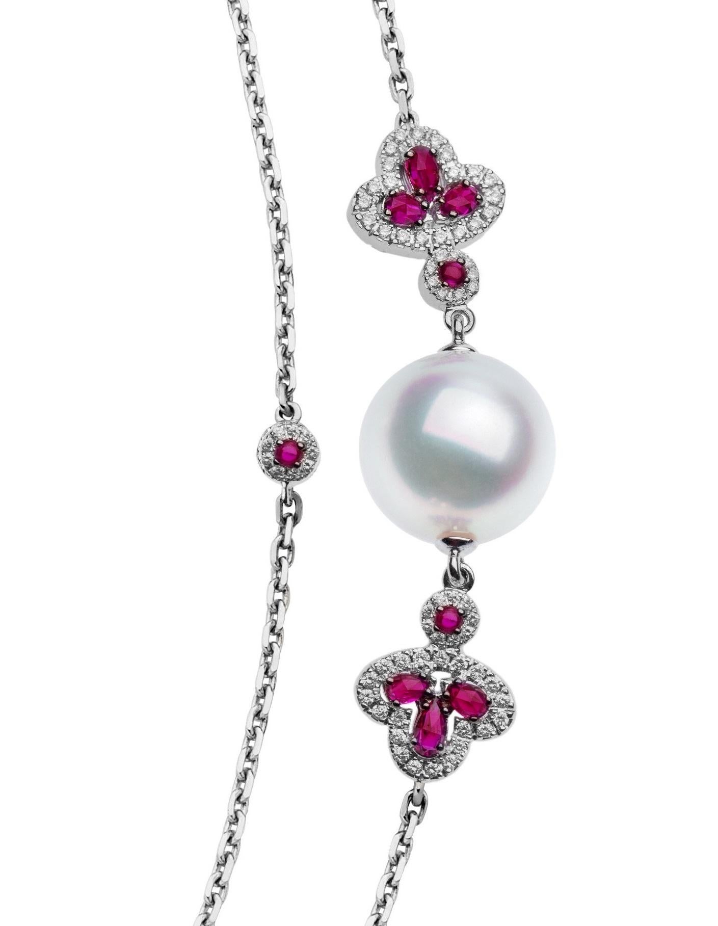 One 18 Karat white gold, 50-inch long necklace comprised of 7-White South Sea pearls, 39 pear-shaped briollet-cut rubies, 40 round cabochon-cut rubies and accent white round brilliant cut diamonds. Each of six pearls that measure approximately 11.0