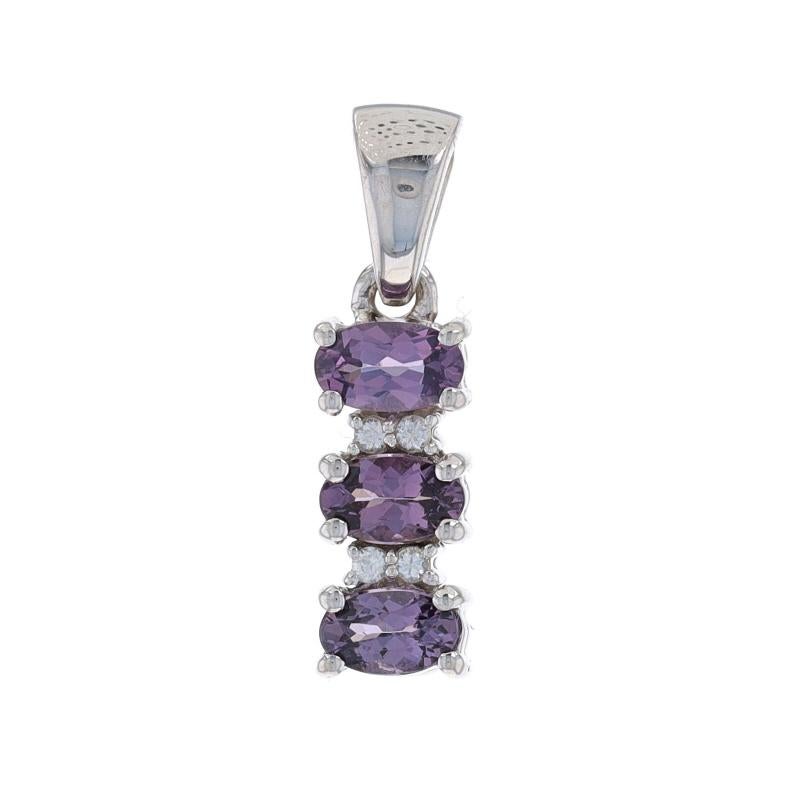 Metal Content: 10k White Gold

Stone Information
Natural Spinels
Carat(s): .66ctw
Cut: Oval
Color: Purple

Natural Topaz
Carat(s): .10ctw
Cut: Round
Color: White

Total Carats: .76ctw

Style: Three-Stone with Accents
Features: East-West Set
