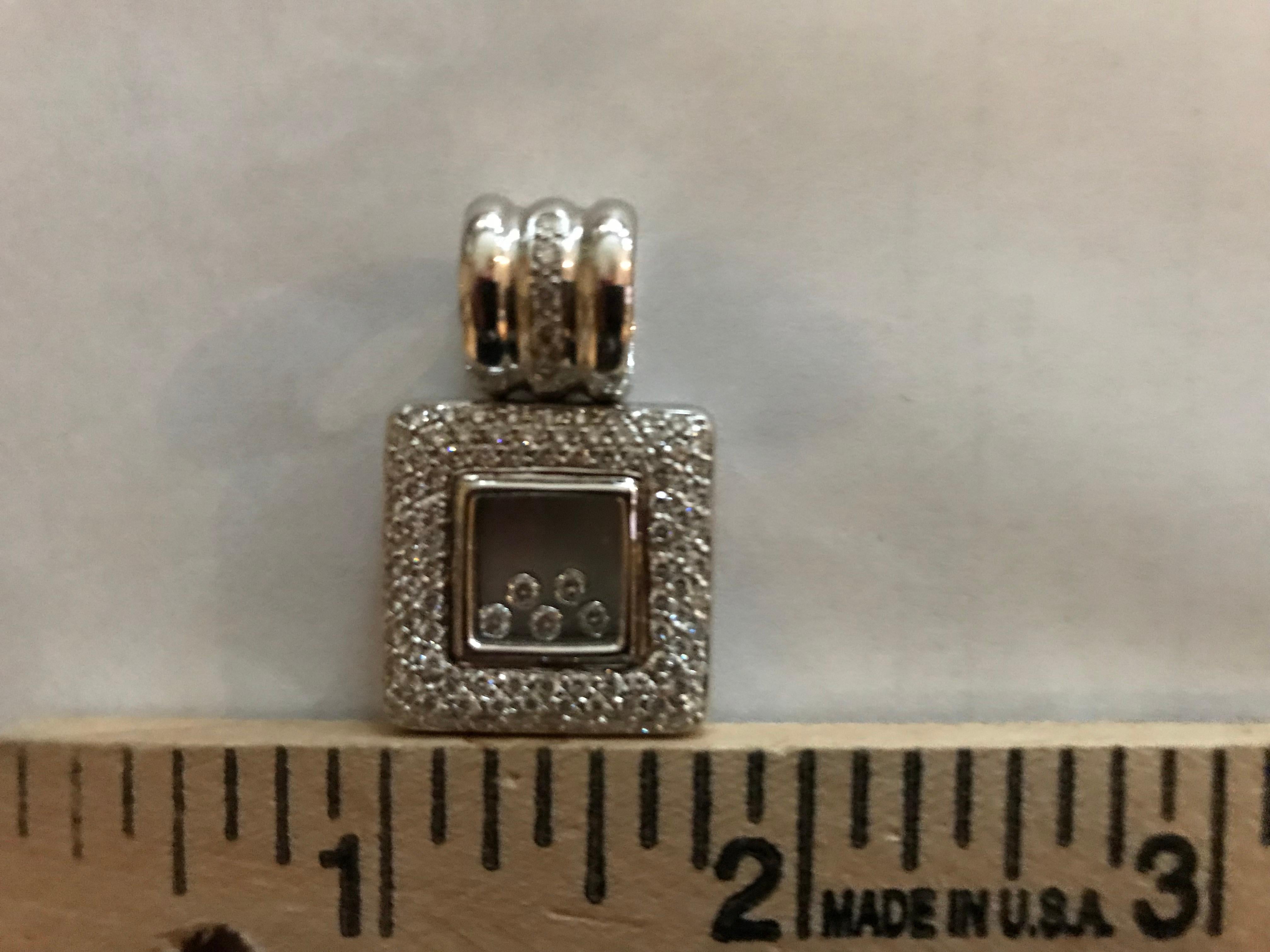 18K white gold slide with pave set diamonds and five bezel set moving diamonds weighing combined 1.38 carats.
Pendant only.