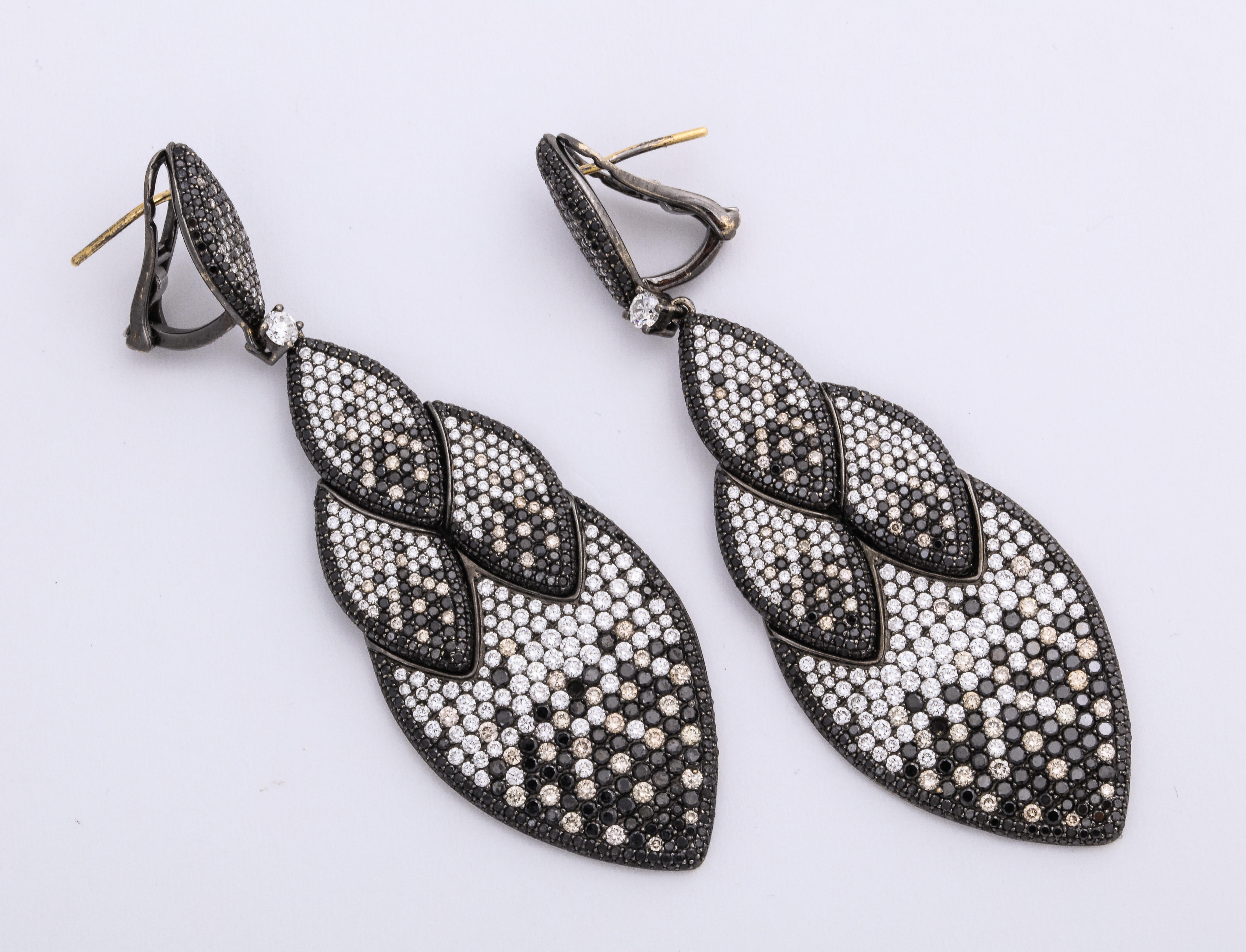 Modern and bold 18 Karat white gold stylized drop earrings decorated with pave'-set round brilliant-cut grey, beige, and colorless diamond stria, with round diamond cut black diamonds: 11.29 carats, with a final black rhodium wash for added detail