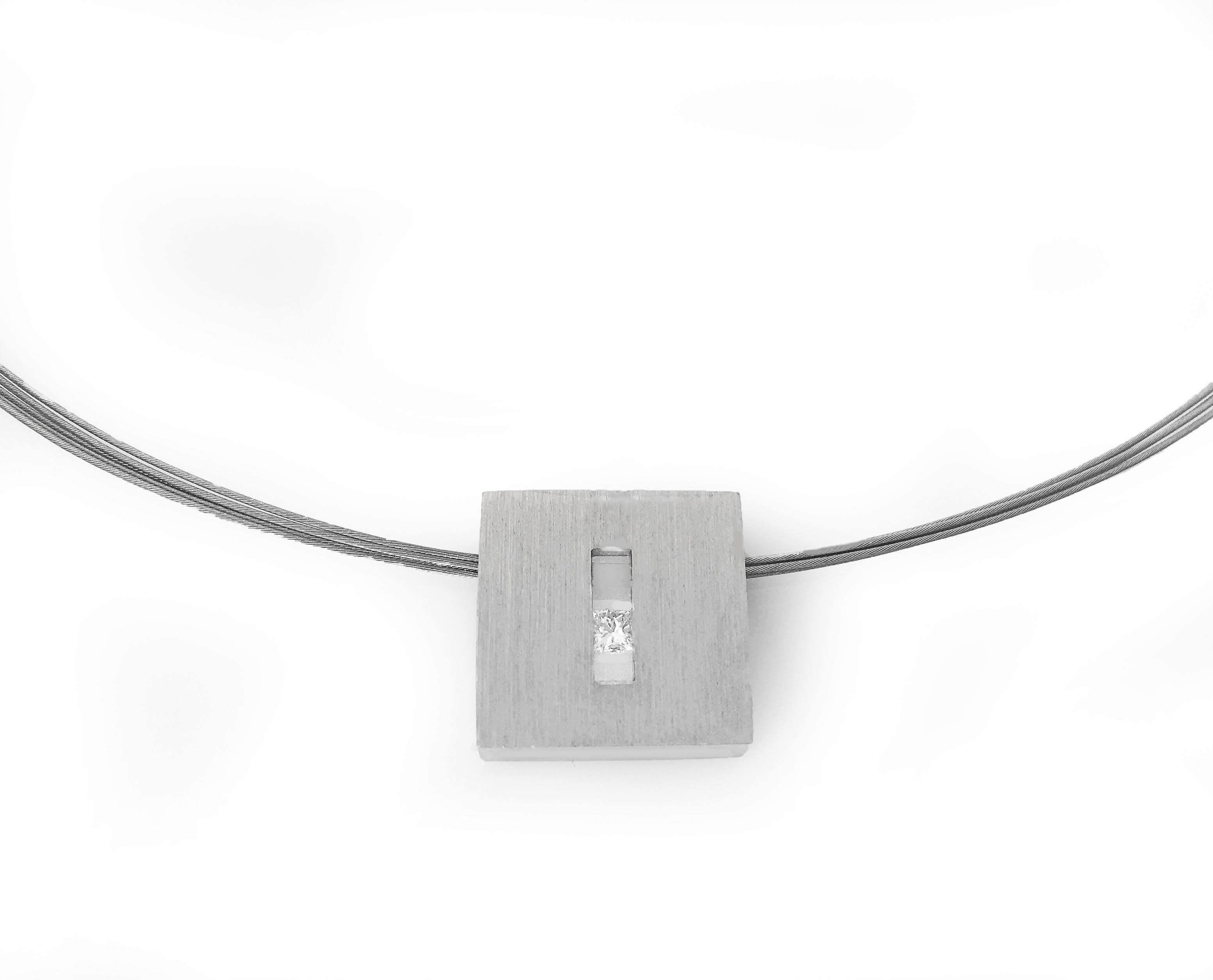 This Princess Diamond in White Gold Suspended Square Pendant is part of our Suspension Collection. Modern and architecturally inspired, this rectangle pendant is shown in white gold with a brushed finish and set off center with an approximately