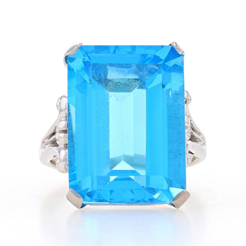 Size: 5 3/4
Sizing Fee: Up 2 sizes for $35 or Down 1 size for $35

Metal Content: 14k White Gold (shank) & Palladium (head)

Stone Information
Natural Topaz
Treatment: Routinely Enhanced
Carat(s): 12.60ct
Cut: Emerald
Color: Swiss Blue
Size: 18mm x