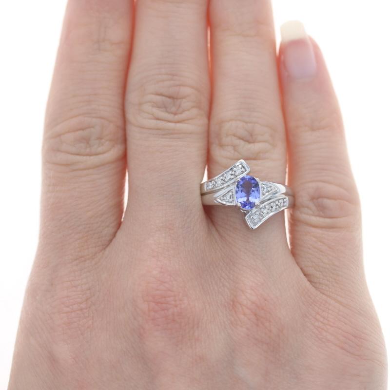 Size: 6 3/4
Sizing Fee: Down 1 size for $35 or up 2 sizes for $40

Metal Content: 18k White Gold

Stone Information

Natural Tanzanite 
Treatment: Routinely Enhanced 
Carat(s): .80ct
Cut: Oval 
Color: Purple

Natural  Diamonds
Carat(s): .10ctw
Cut: