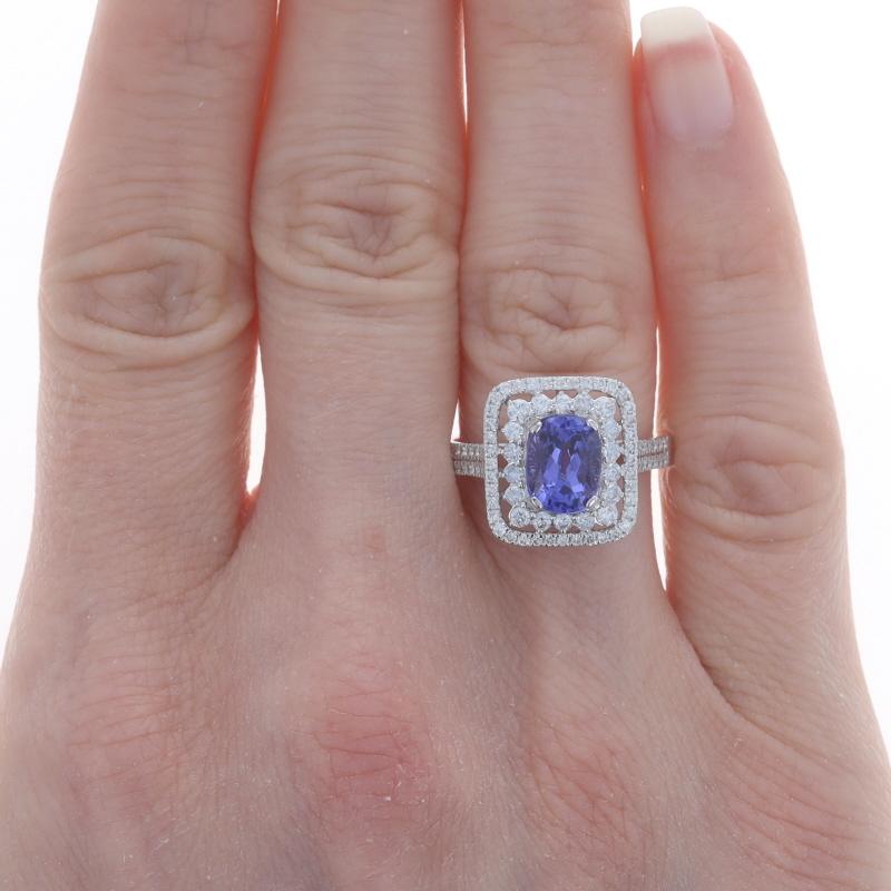 Size: 6 1/2
Sizing Fee: Up 2 sizes for $50

Metal Content: 18k White Gold

Stone Information
Natural Tanzanite
Treatment: Routinely Enhanced
Carat(s): 1.89ct
Cut: Rectangular Cushion
Color: Purple

Natural Diamonds
Carat(s): .64ctw
Cut: Round