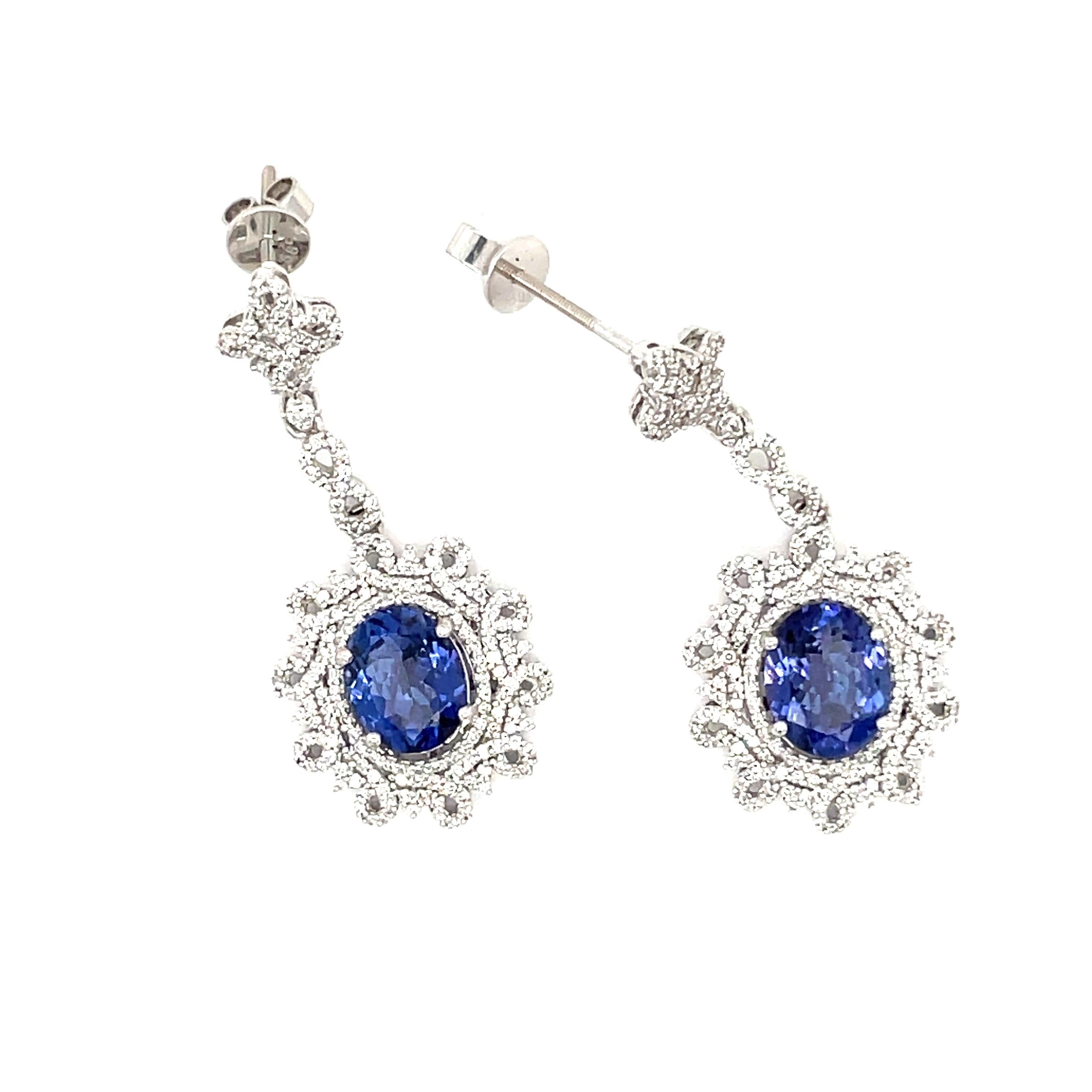 14K White Gold Tanzanite, Diamond Drop Earrings.
4.70CTW Tanzanite and 1.38CTW Diamonds
8.58 Grams 
1.5 inches long
.5 inches wide 
Posts have screwbacks for safety but this can be changed upon request. 