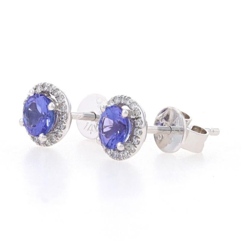 Metal Content: 14k White Gold

Stone Information
Natural Tanzanites
Treatment: Routinely Enhanced
Carats: .62ctw
Cut: Round
Color: Purple

Natural Diamonds
Carats: .08ctw
Cut: Single
Color: F - G
Clarity: VS1 - VS2

Total Carats: .70ctw

Style: Halo