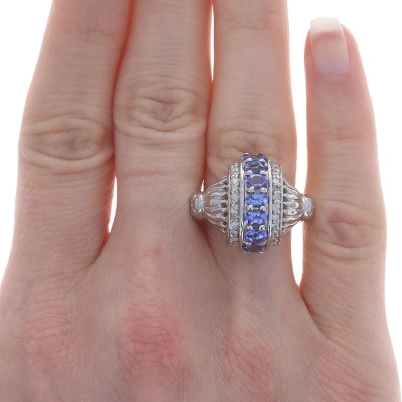 Size: 8

Metal Content: 14k White Gold

Stone Information
Natural Tanzanites
Treatment: Routinely Enhanced
Carat(s): 1.05ctw
Cut: Oval
Color: Purple

Natural Diamonds
Carat(s): .36ctw
Cut: Round Brilliant
Color: G - H
Clarity: I1 - I2

Total Carats: