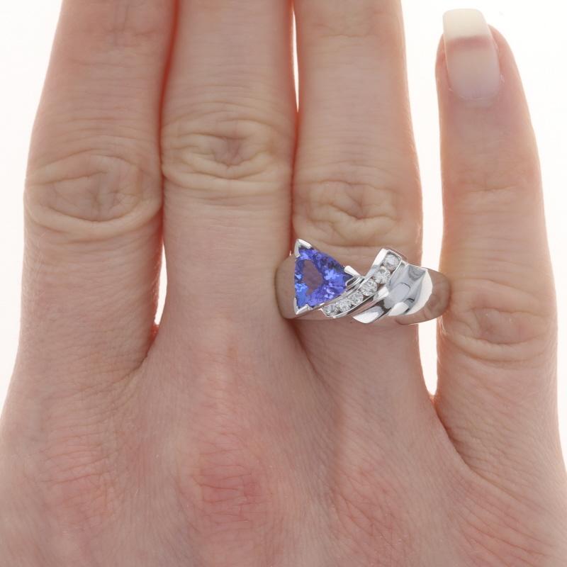 Size: 8
Sizing Fee: Up 1 size for $40 or Down 1 size for $40

Metal Content: 14k Yellow Gold

Stone Information

Natural Tanzanite
Treatment: Routinely Enhanced
Carat(s): 1.40ct
Cut: Trillion
Color: Purple

Natural Diamonds
Carat(s): .25ctw
Cut: