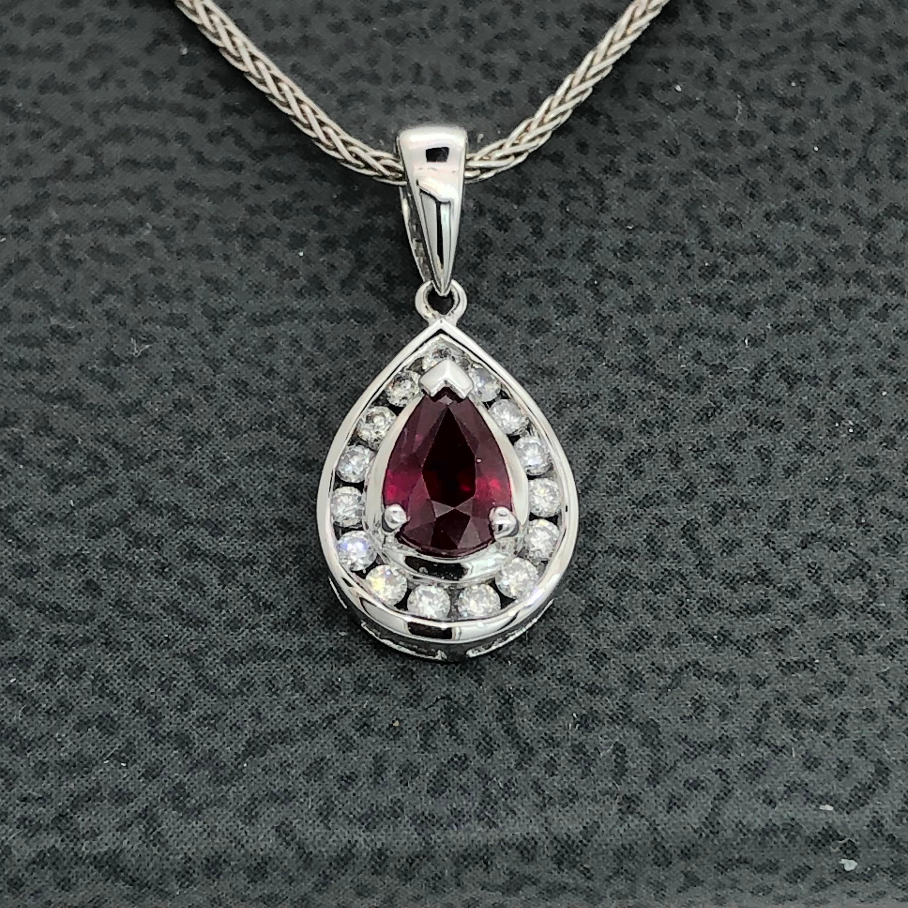 Classic pendant in 18 carat white gold
Set with one pear shape natural Ruby weighing 0.68 carats 
surrounded by 15 channel set Diamons totally weighing 0.18 carats
Pendant length including bail is 19.0 mm
Teardrop dimensions are 12.0 mm x 9.0