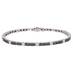 Bracelet tennis en or blanc serti de diamants noirs et blancs