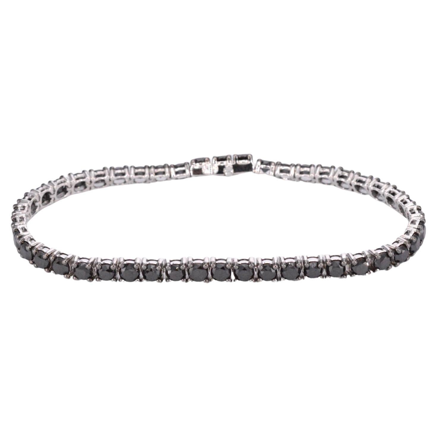 Embrace a touch of mystery with the white gold tennis bracelet set with black diamonds. This exquisite bracelet is crafted in white gold and adorned with enchanting black diamonds. The black diamonds add a sense of elegance and allure, contrasting