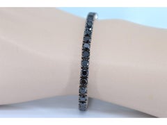 Bracelet tennis en or blanc serti de diamants noirs