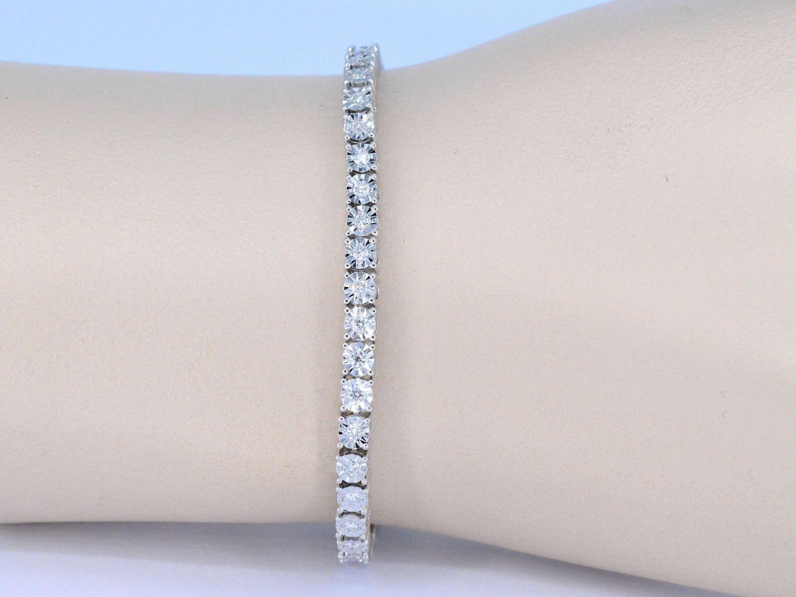 This white gold tennis bracelet with diamonds is a stunning piece of jewelry that is sure to make a statement. Featuring 1.20 carats of brilliant cut diamonds, this bracelet sparkles and shines from every angle. The diamonds have a F-G color and