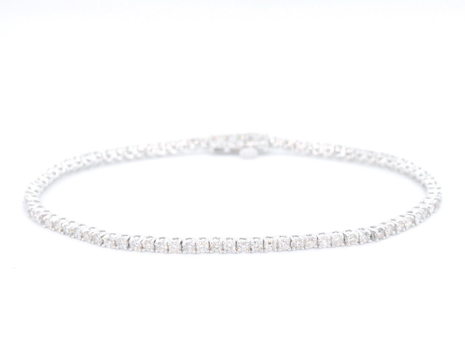 This gorgeous white gold tennis bracelet features 2.50 carats of brilliant cut diamonds, providing incredible sparkle and fire. The diamonds are set in a classic prong setting, ensuring they are secure while still allowing for maximum light