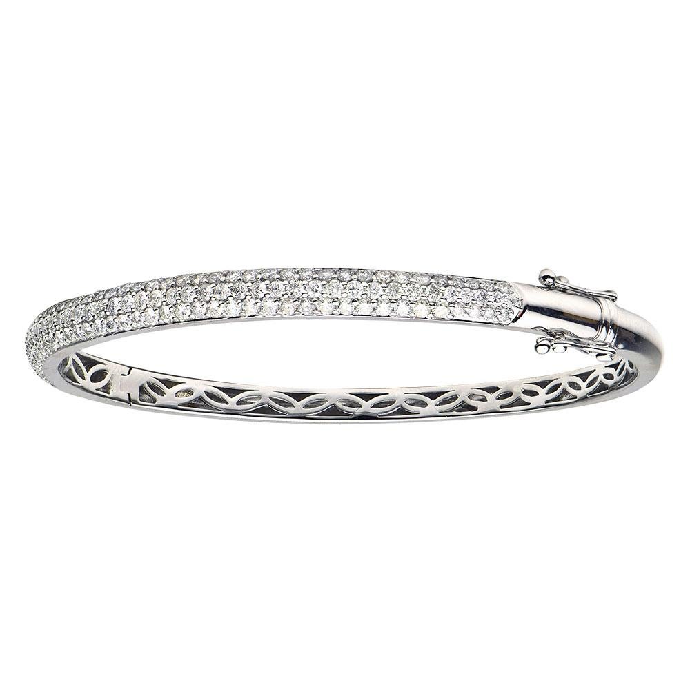 Fashion and glam are at the forefront with this exquisite diamond bangle. This 14-karat white gold bracelet is made from 10.5 grams of gold. The top is adorned with three rows of SI1-0SI2, GH color diamonds made out of 127 diamonds totaling 2.08