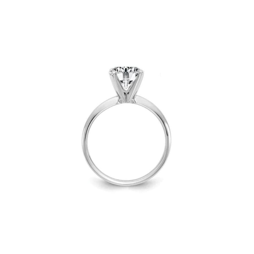 Classic 14k White Gold Tiffany Style Solitaire Diamond Engagement Mounting﻿. Four prong white gold head holds a round brilliant cut natural white diamond, 0.66 ct weight, G color, VVS2 clarity. 