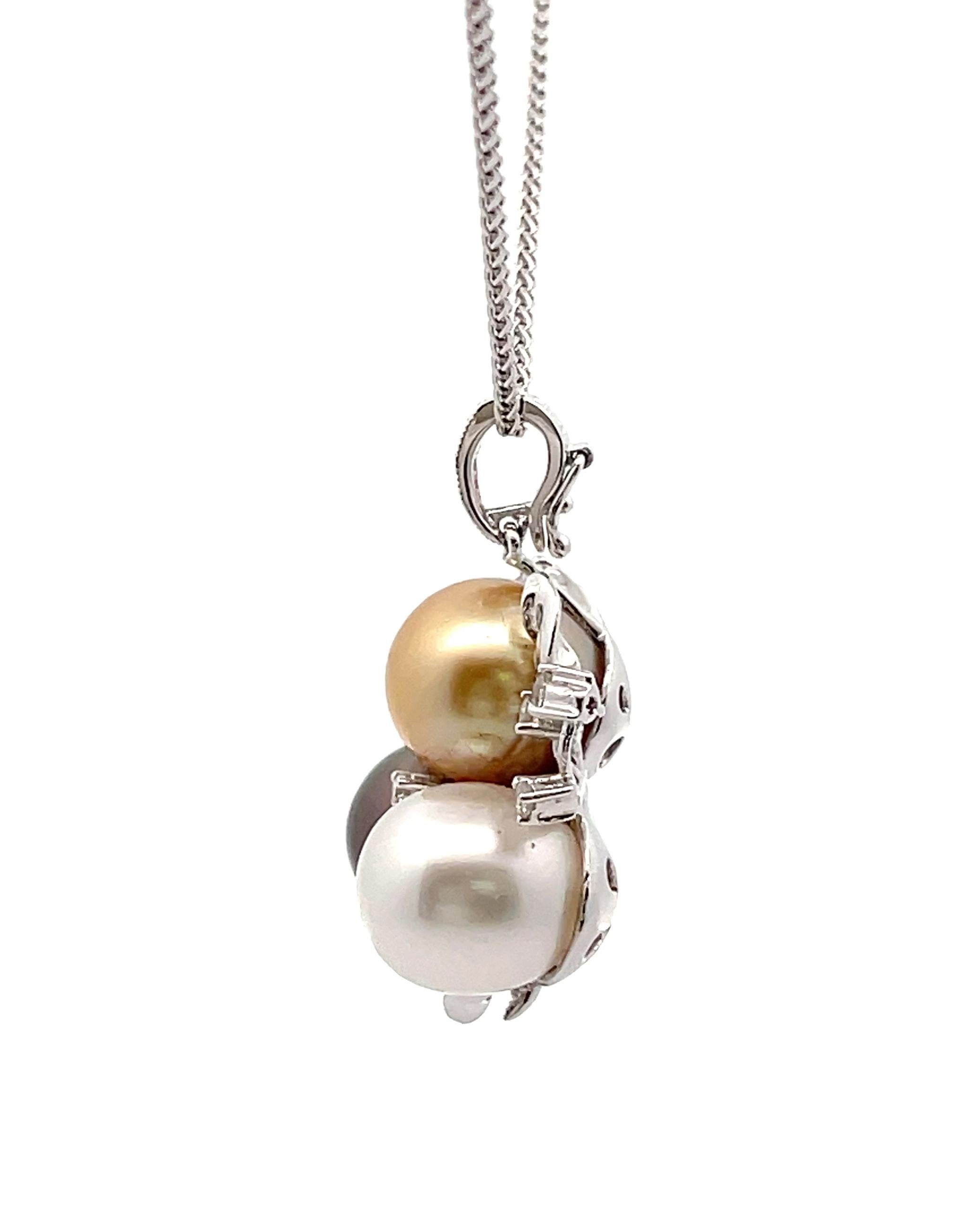 18K white gold pendant with baguette and round diamonds weighing 1.20 carats total and three colors South Sea pearls measuring 10-11mm each. Colors include white South Sea, black Tahitian and golden South Sea.
Pendant slides on a 14K white gold