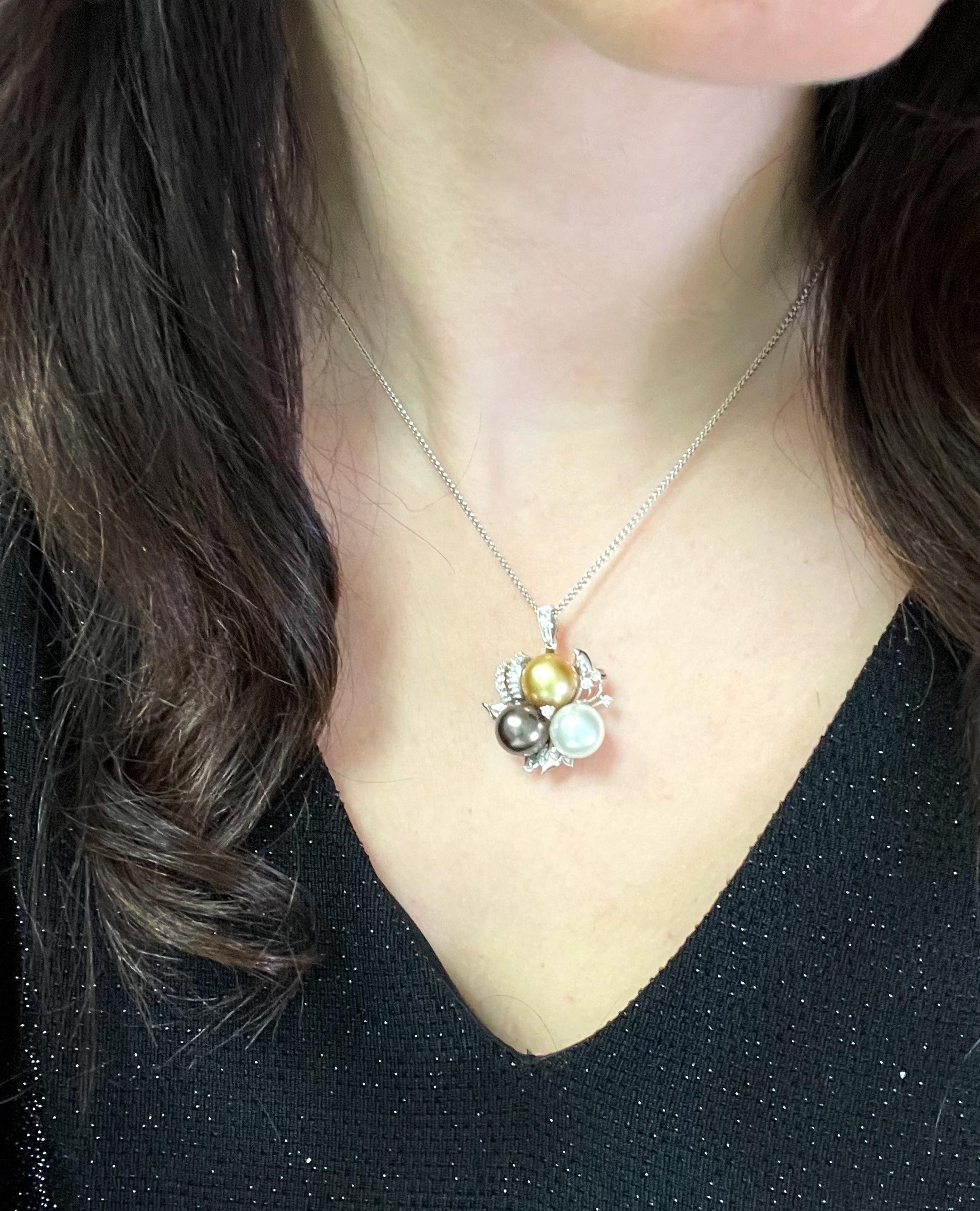 18K white gold pendant with baguette and round diamonds weighing 1.20 carats total and three colors South Sea pearls measuring 10-11mm each. Colors include white South Sea, black Tahitian and golden South Sea.
Pendant slides on a 14K white gold