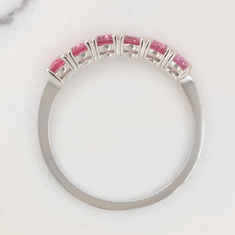 A fantastic 14k white gold band ring with extremely elegant pink spinel stones. The spinels are a beautiful peach pink color, perfect for the white gold setting. All the spinels are set respecting a slight shade that goes from light to dark. All the