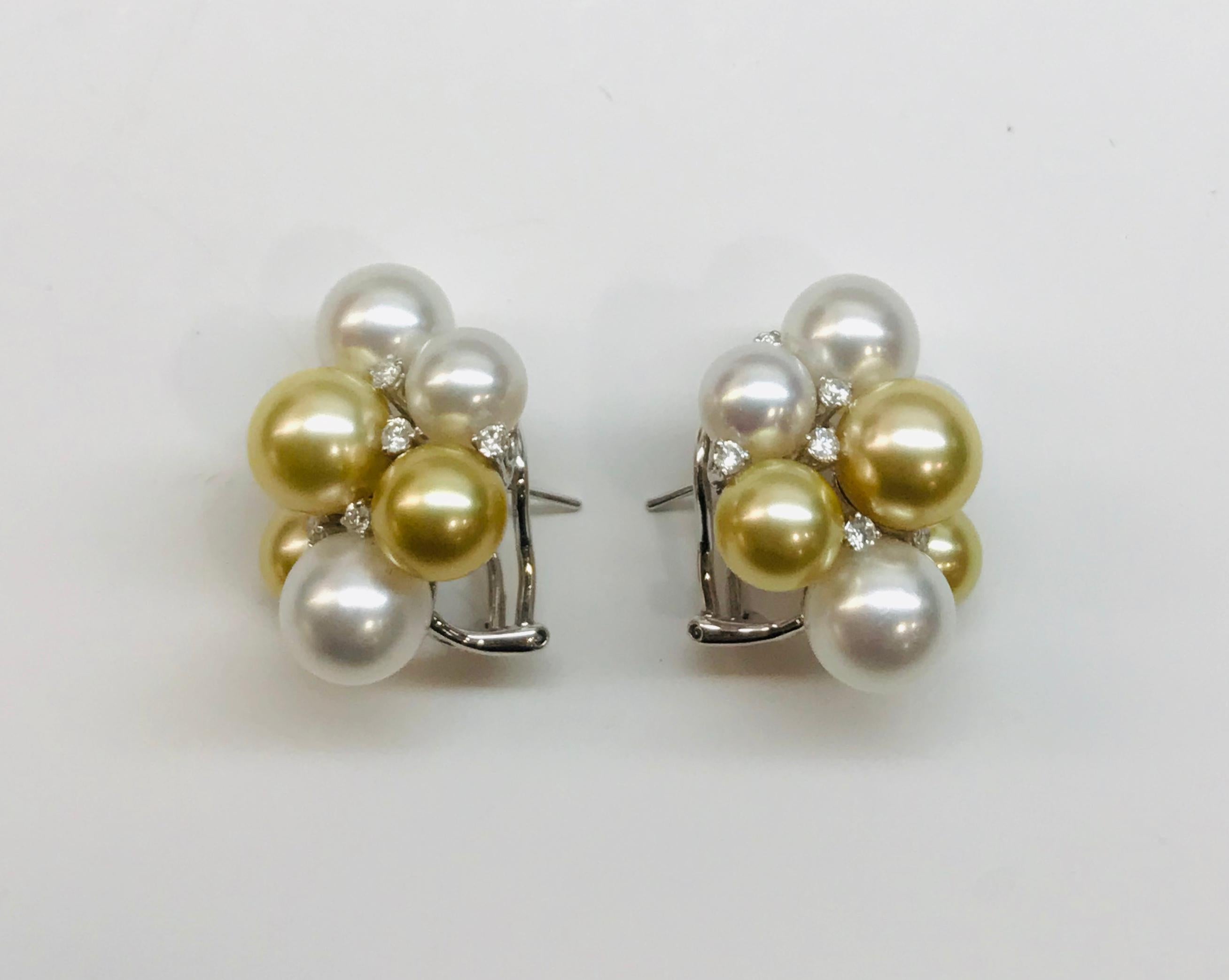 One pair of 18K white gold cluster pearl and diamond earrings with clip and post. Each earring includes 4-White and 3- Golden South Sea pearls of various sizes ranging between 8-10 mm, interspersed with 8 small round brilliant cut diamonds. The