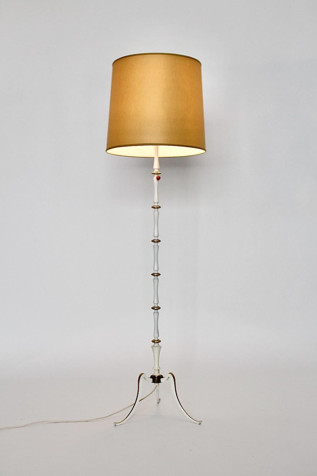 Mid-Century Modern white and golden vintage floor lamp from metal designed and executed 1950s Italy.
The floor lamp, which was designed in the mid century modern era in Italy features golden lacquered details and a white stem.
Its Hollywood