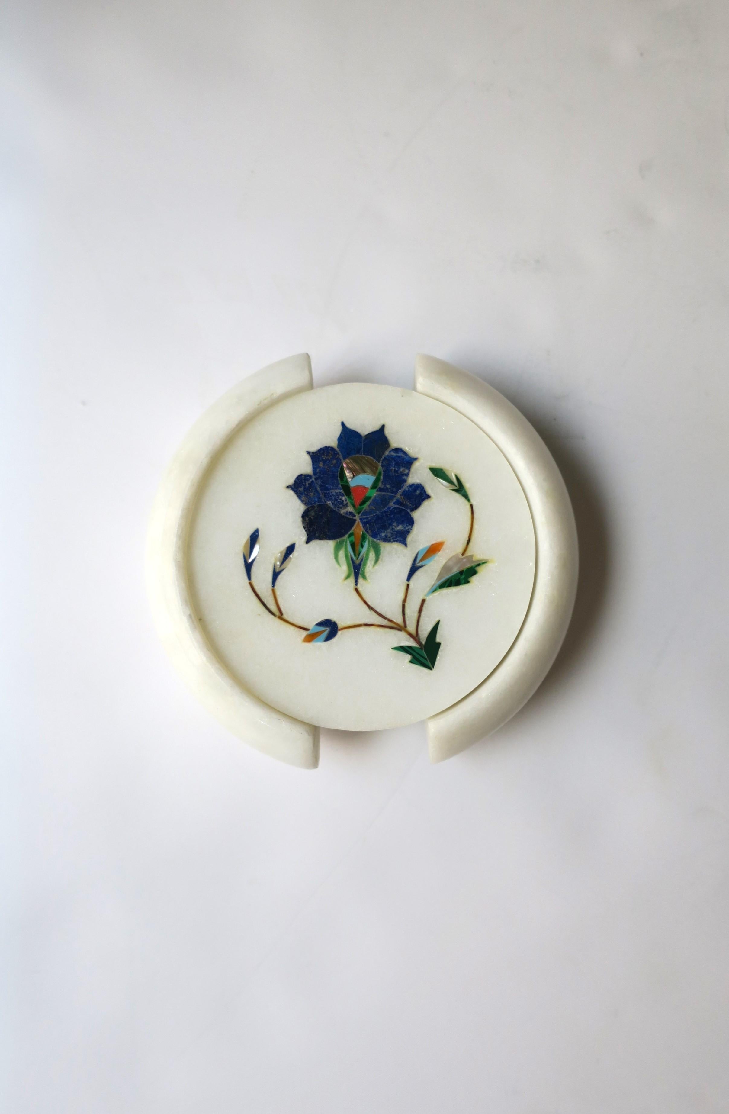 A beautiful set of six (6) handmade white granite marble coasters with inlaid design, in the style of Anglo Raj, circa late-20th century, India. The white granite marble is inlaid with various semi-precious stones including, blue lapis lazuli,