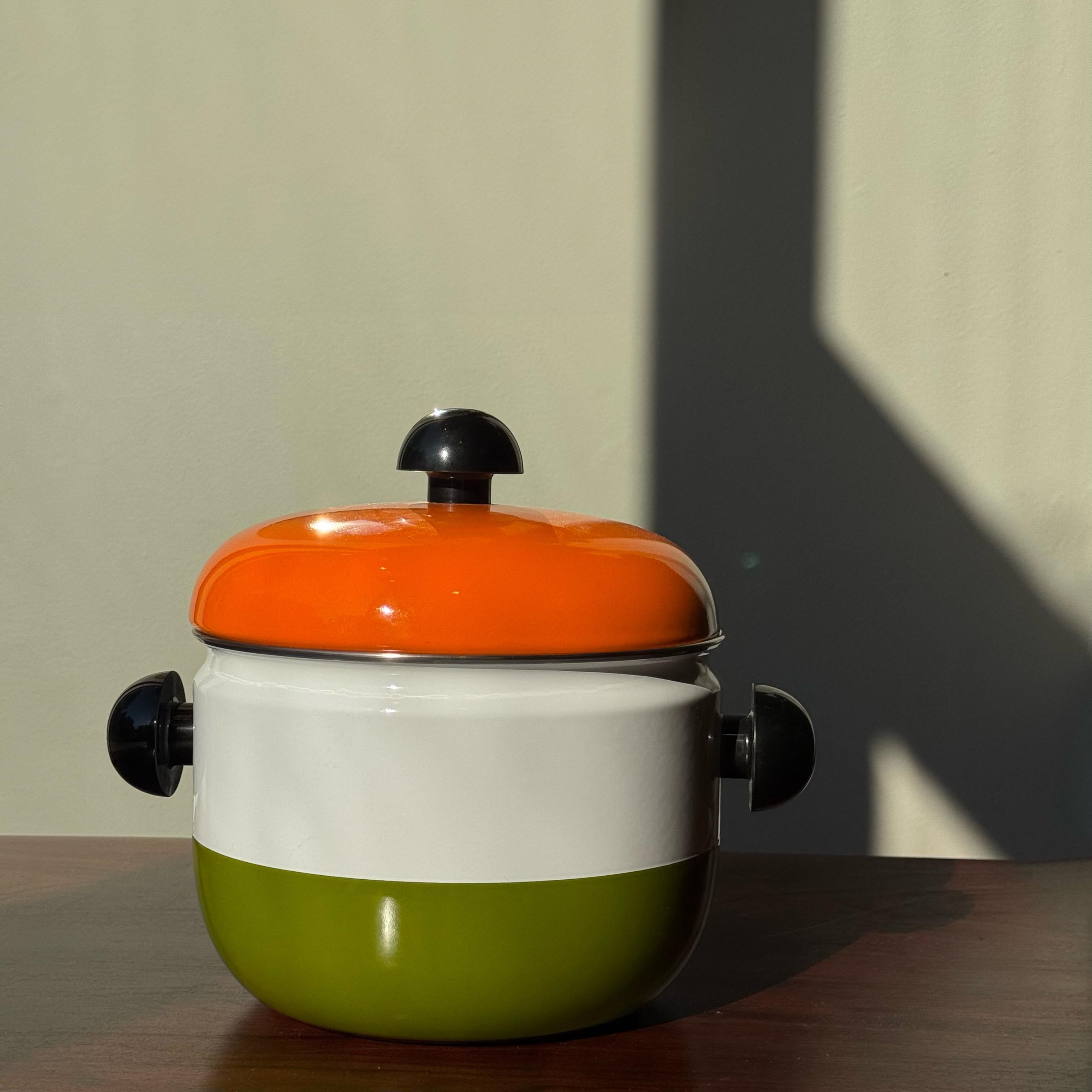 Description:

An enamelled metal stove pot, designed during the 1970s by Carl Auböck III during the 1970s. 

Suitably seventies with its vivid orange lid and graphic striped profile, this enamelled metal stove pot was part of a series of cookware