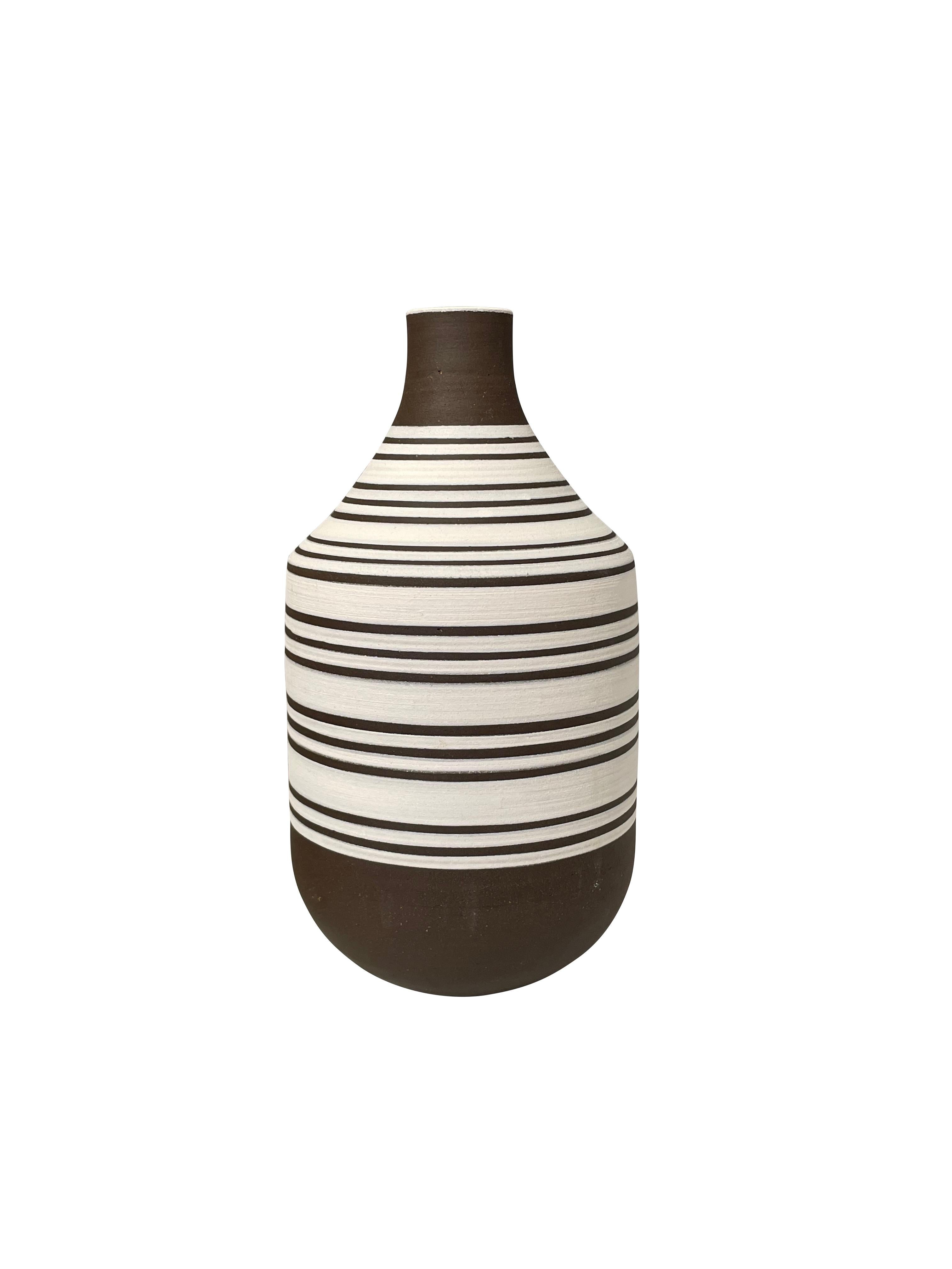Contemporary Turkish white ground vase with dark brown triple stripes.
Dark brown top and bottom with small opening.
Can hold water.
Two available and sold individually.