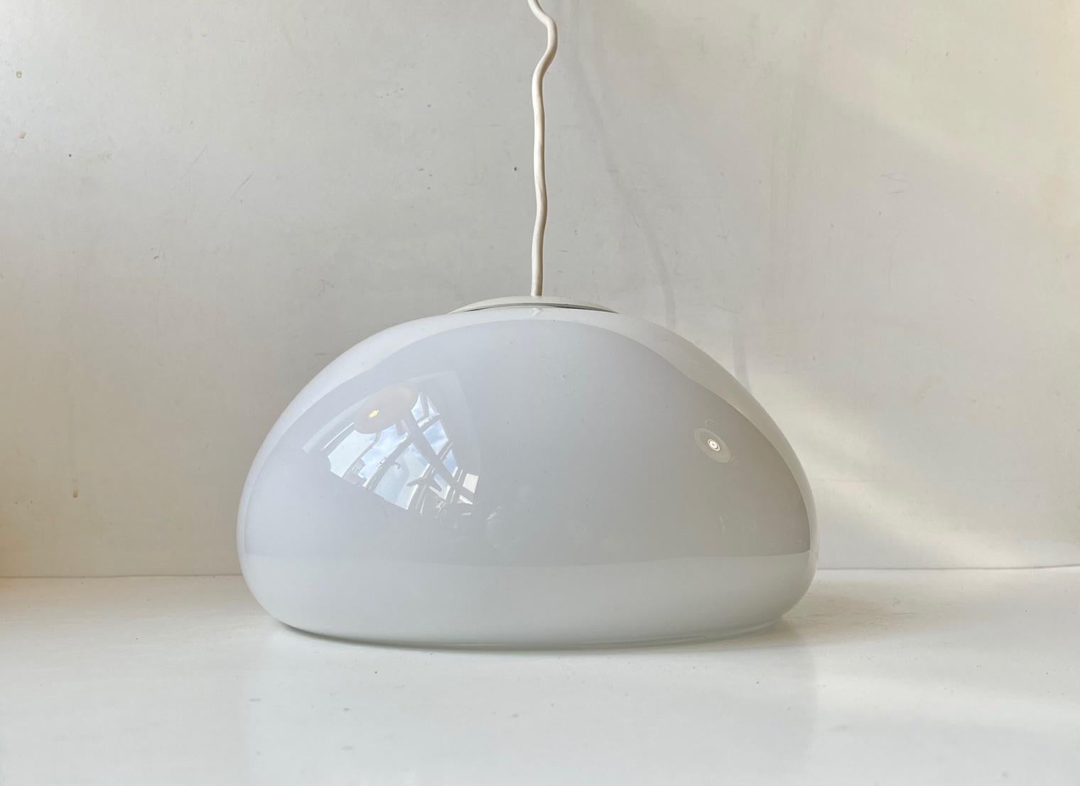A rare hand-blown cased white opaline glass pendant light designed by Per Lütken and manufactured by Holmegaard in Denmark during the late 1970s or early 80s. It is called Sunset and is characterized by its almost mushroom shape. Measurements: