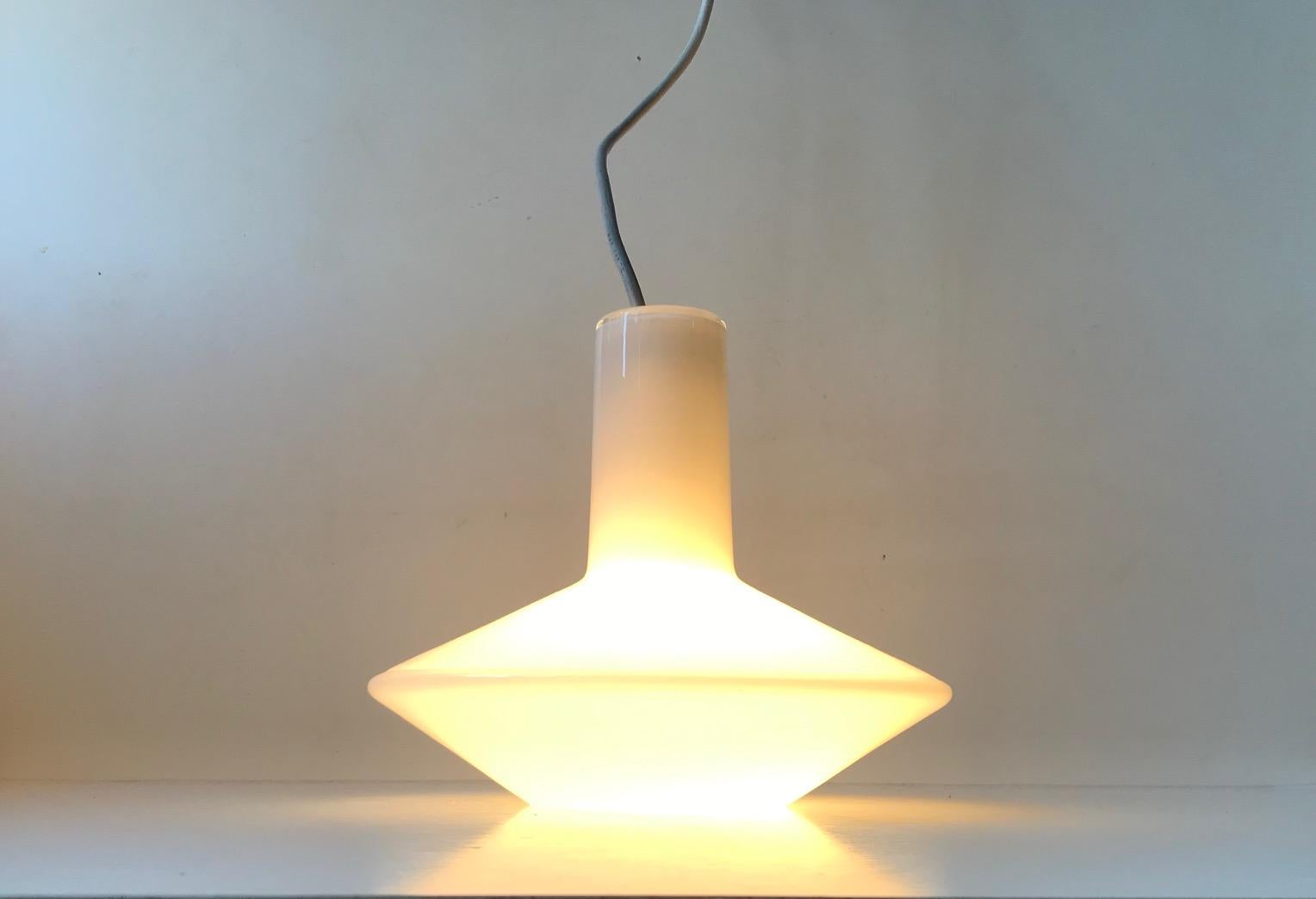A rare cased white opaline glass pendant light designed by Sidse Werner and manufactured by Holmegaard in Denmark during the late 1970s or early 1980s. It is like Piet Hein's lamp series called Sinus.