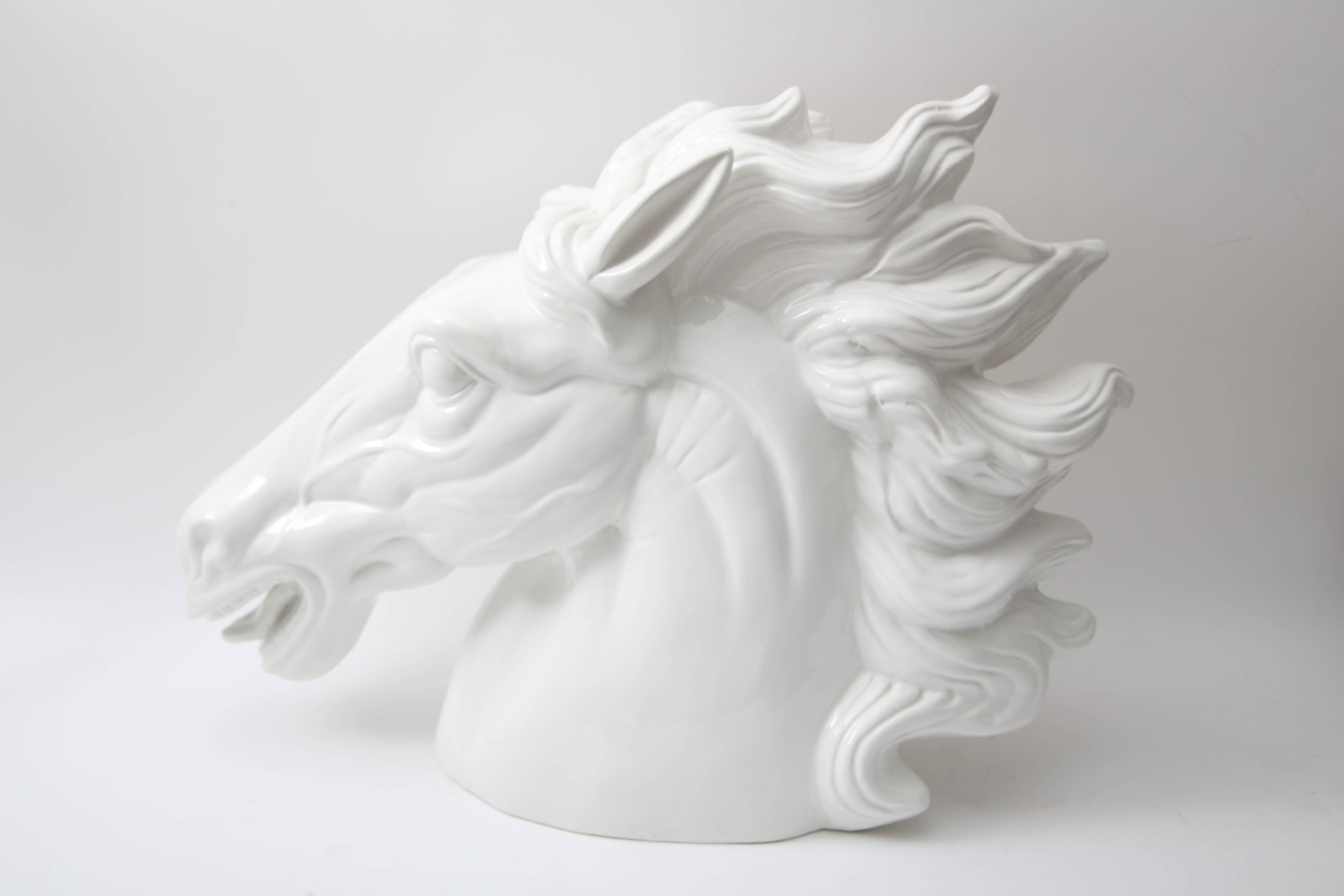 This large-scale figure of a horse head was produced in Italy and dates to the late 20th century. The white glaze gives this piece a modern look and captures the elegance and beauty of the horse.