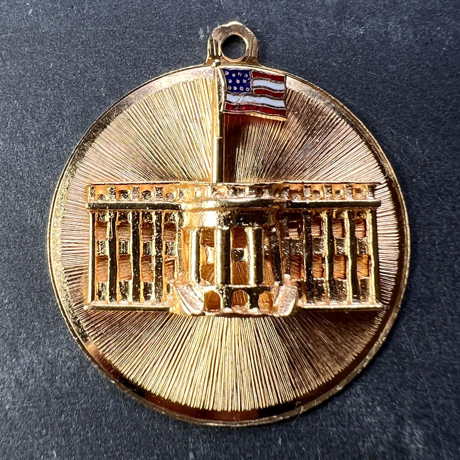 A 14 karat (14K) yellow gold patriotic charm pendant depicting the White House with enamel detail to the American Flag. Signed AC and stamped 14K for 14 karat gold.

Dimensions: 2.9 x 2.6 x 0.45 cm 
Weight: 5.14 grams
(Chain not included)
