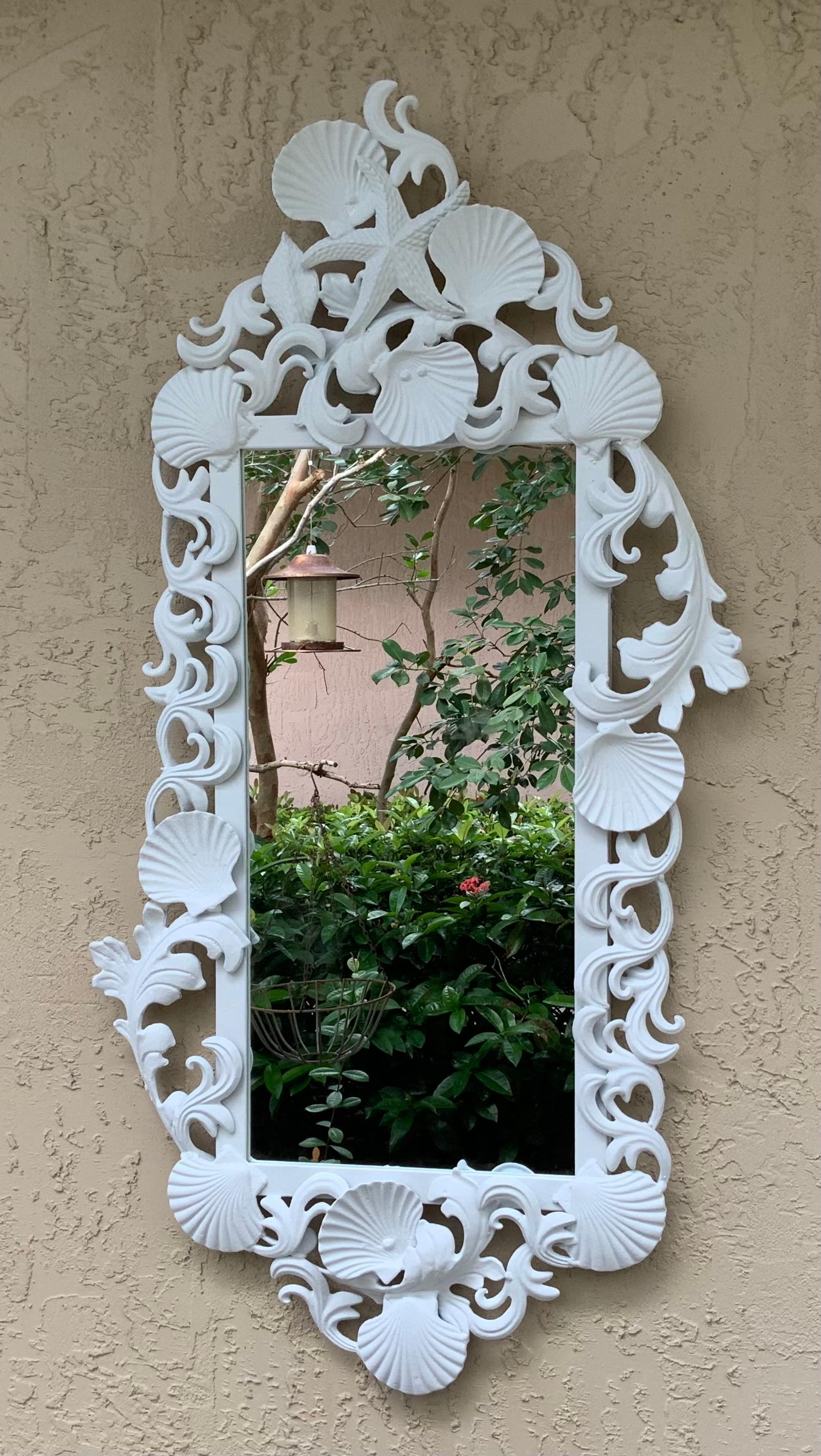 Exceptional mirror made of iron, artistically decorated with seashell and sea star motifs, painted with flat white oil painting color.
Actual mirror size: 22”.5 x 10”25.