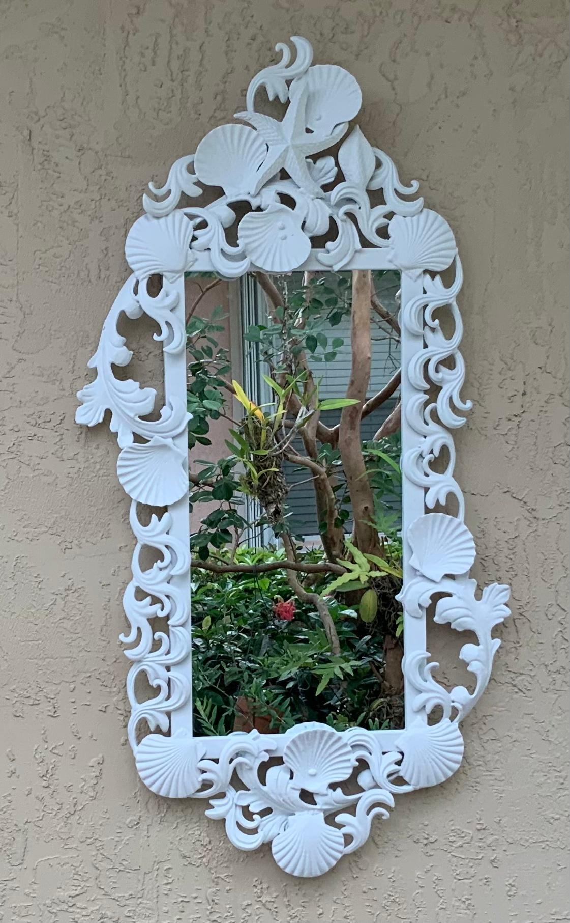 Exceptional mirror made of iron, artistically decorated with seashell and sea star motifs, painted with flat white oil painting color.
Actual mirror size: 22”.5 x 10”25.