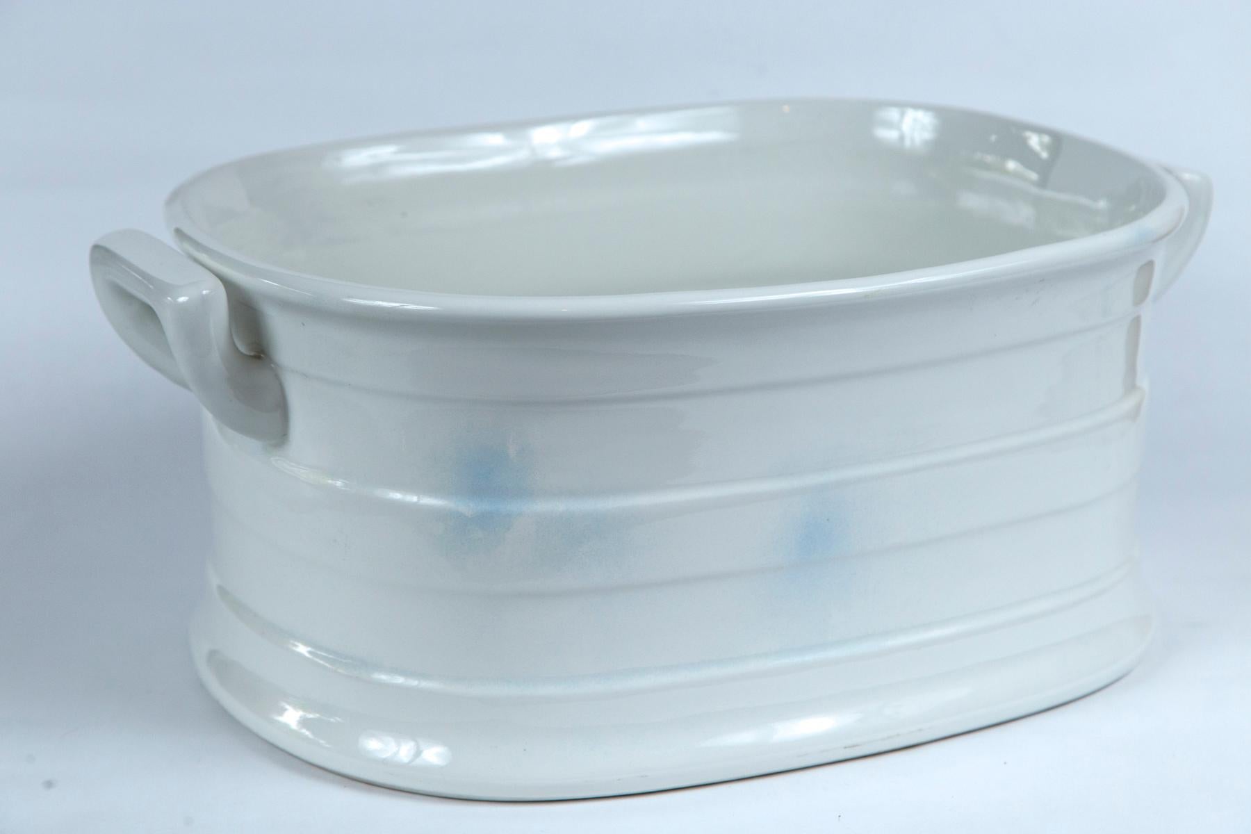 White ironstone foot bath, circa 1920s. Oval shape with banding and double handles. Marked on bottom, Carbone, an importer and distributer of European ceramics.