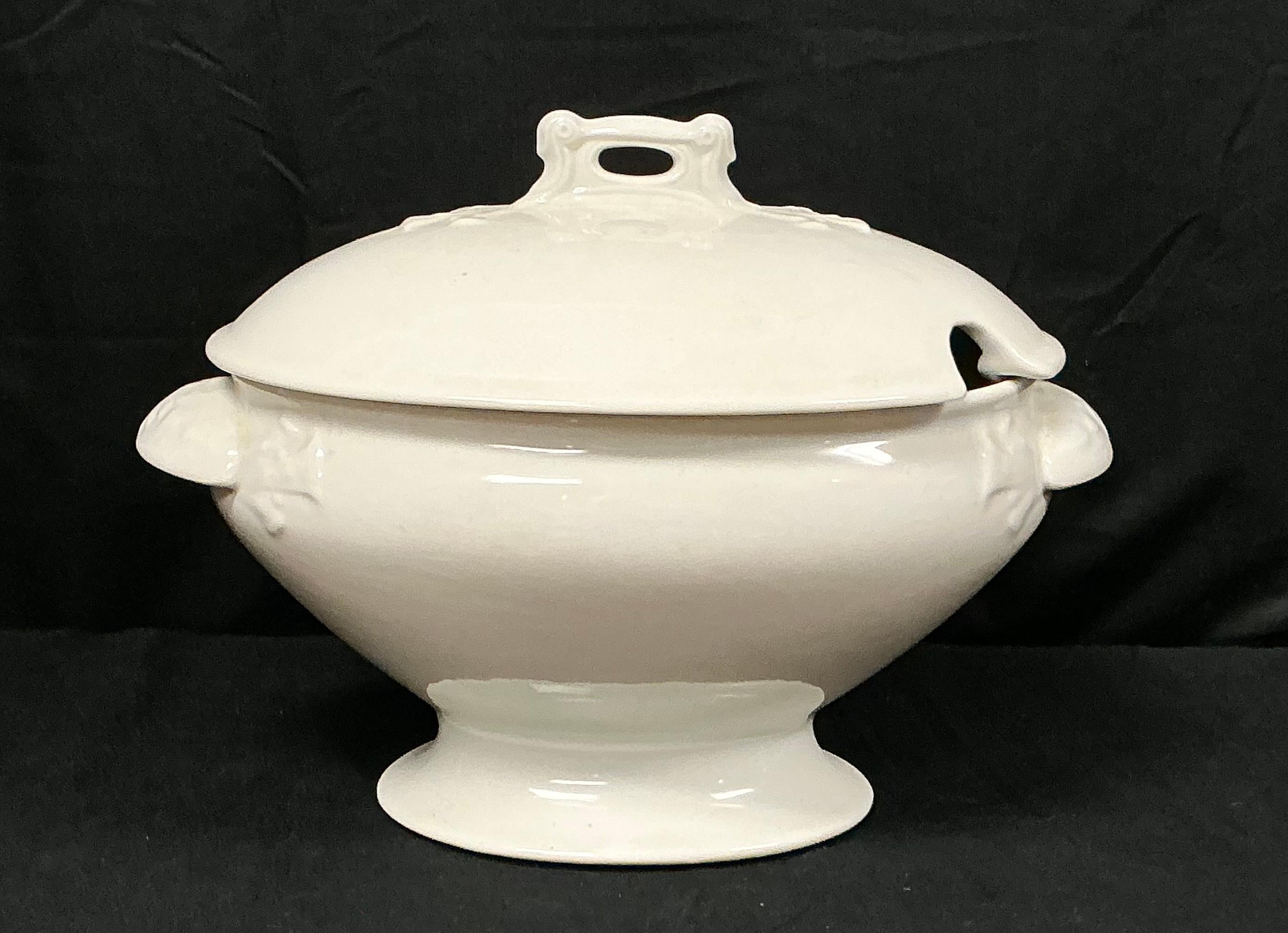 Elegant 19th Century White Ironstone Soup Tureen with Lid. Tureen features a graceful pedestal base, delicately molded side handles, and a domed lid with molded scrolled top handle and ladle notch (ladle not included). Ironstone was known for its