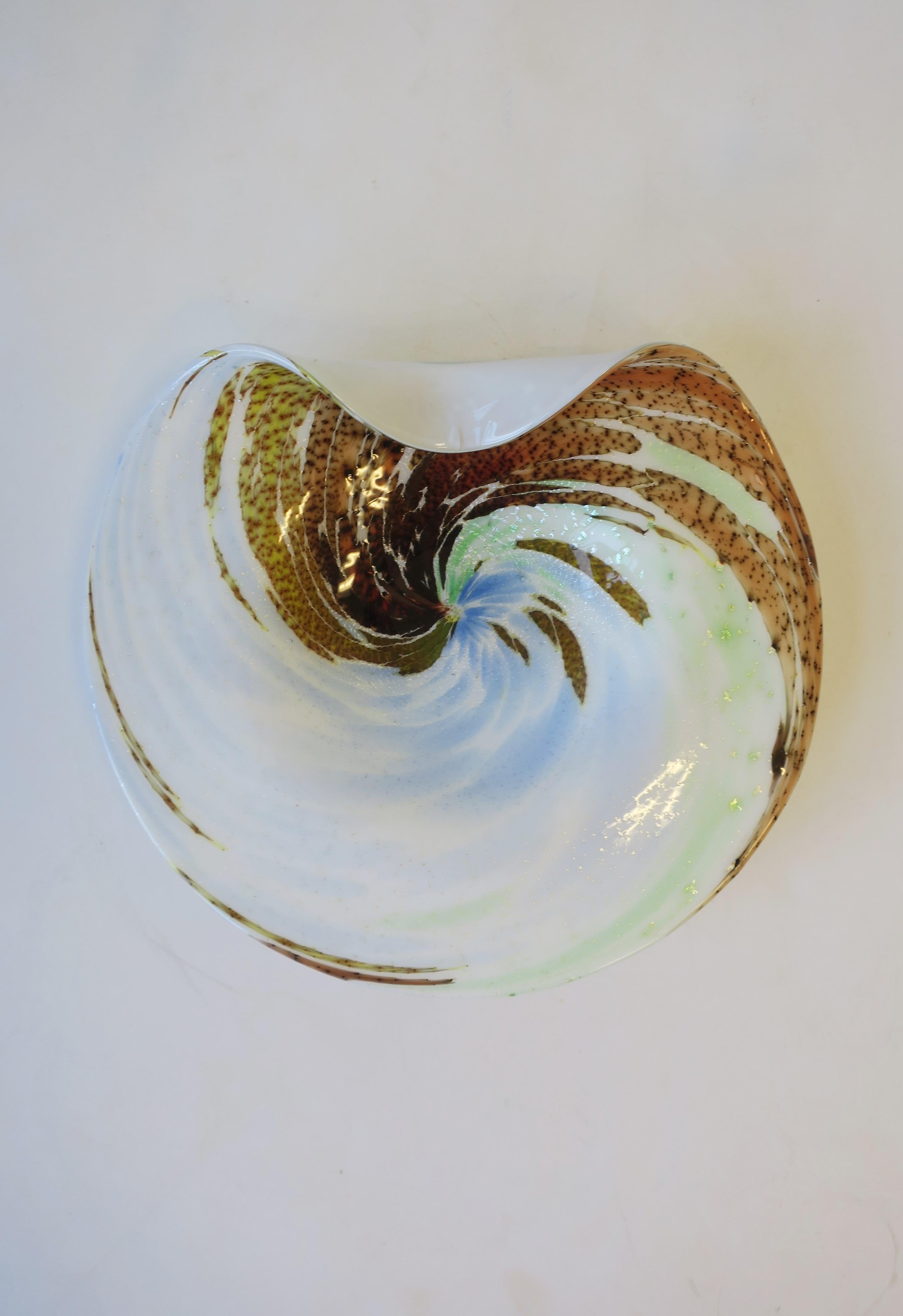 A Modern Italian Murano art glass bowl with an organic wave-like design, circa mid-20th century, Italy. Bowl is predominantly white with light blue, light green, yellow, red burgundy, and light orange art glass, and a sprinkling of silver flecks,