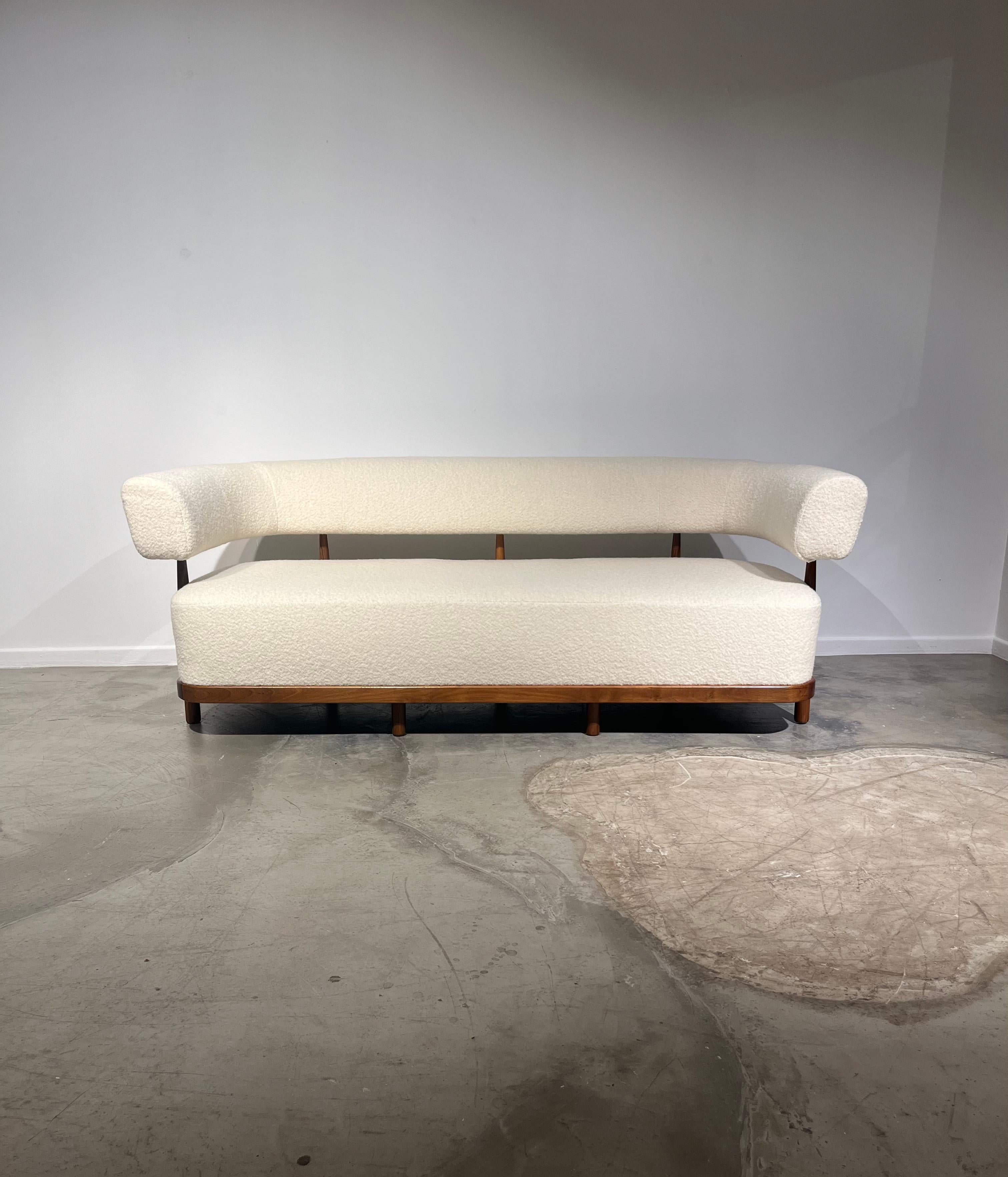 Interesting 3 seats sofa with wood structure and white bouclette fabric.