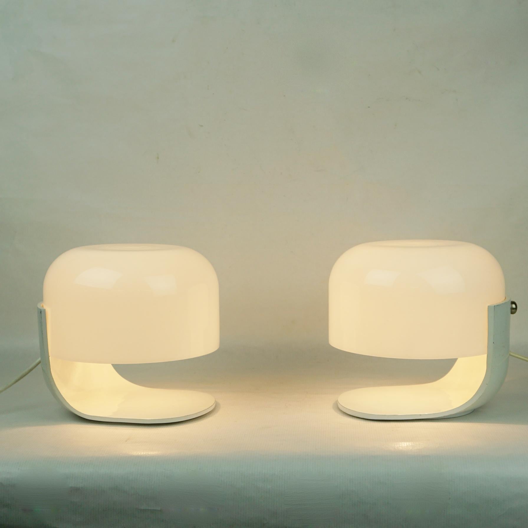 This rare and iconic Pair of small white Space Age Table lamps were designed by Pia Guidetti Crippa for Lumi Milano Italy in the 1960s.
They feature a white lacquered base with a white opaline glass shade, each with one E14 light socket.
 On the