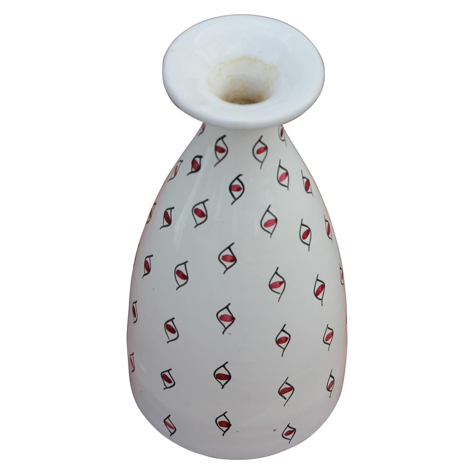 Decorative white vase handmade in Italy for Raymor with a beautiful red and black eye pattern covering the entire piece. This piece could also be used as a fantastic vase or decorative ceramic accent in any home.