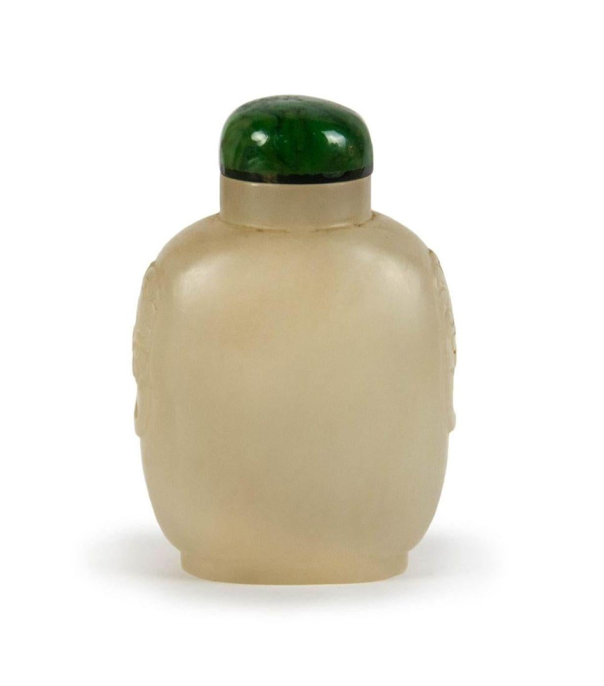 This elegant snuff bottle is finely carved from natural white jade and paired with a natural jadeite stopper. Measuring approximately 7.5 x 5 x 3.5 cm and weighing around 154 grams, it exemplifies refined craftsmanship and timeless beauty.

Snuff