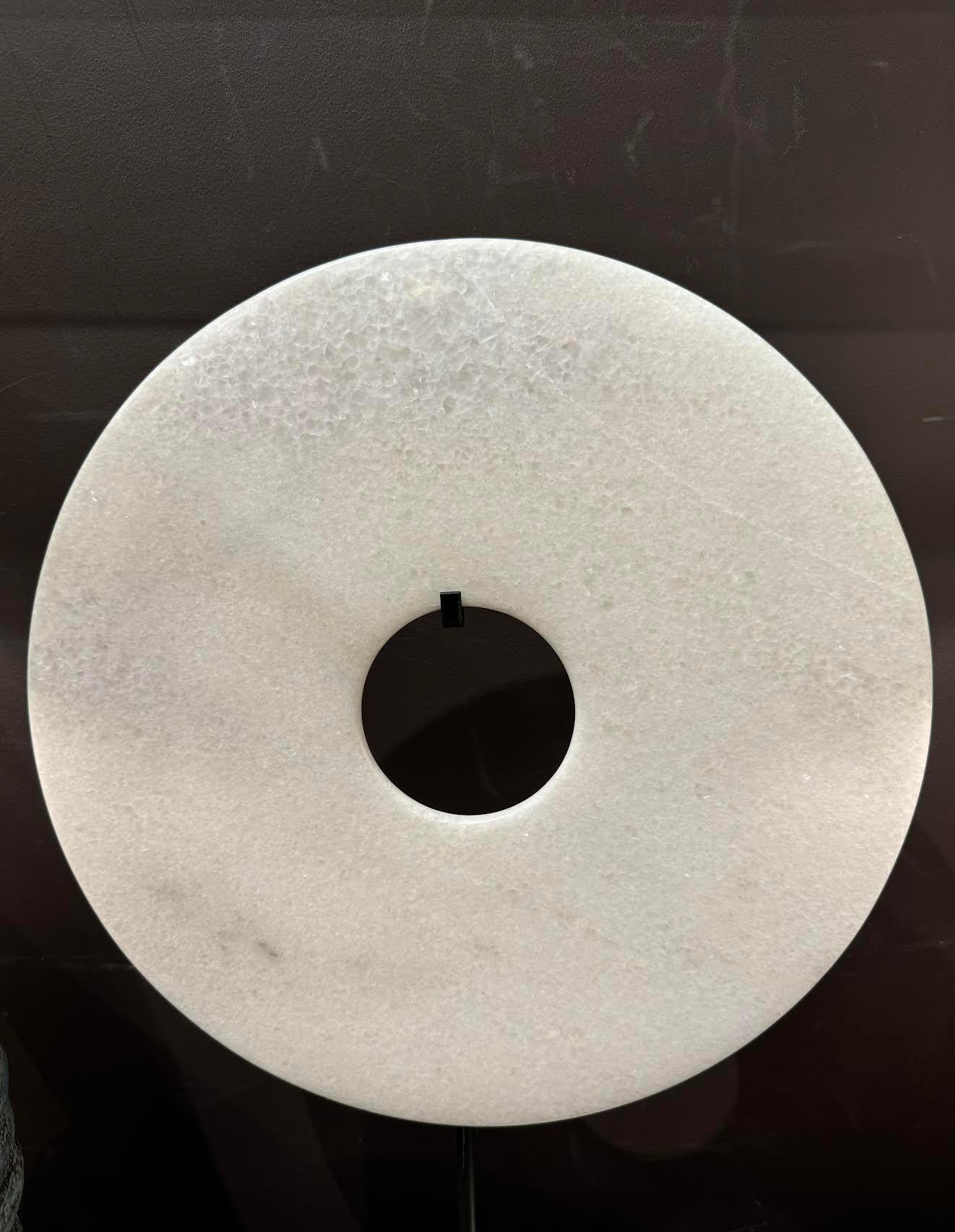 Contemporary Chinese white jade disc on stand.
14