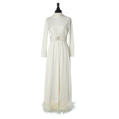 White jersey evening dress with rhinestone belt buckle and white feather edge