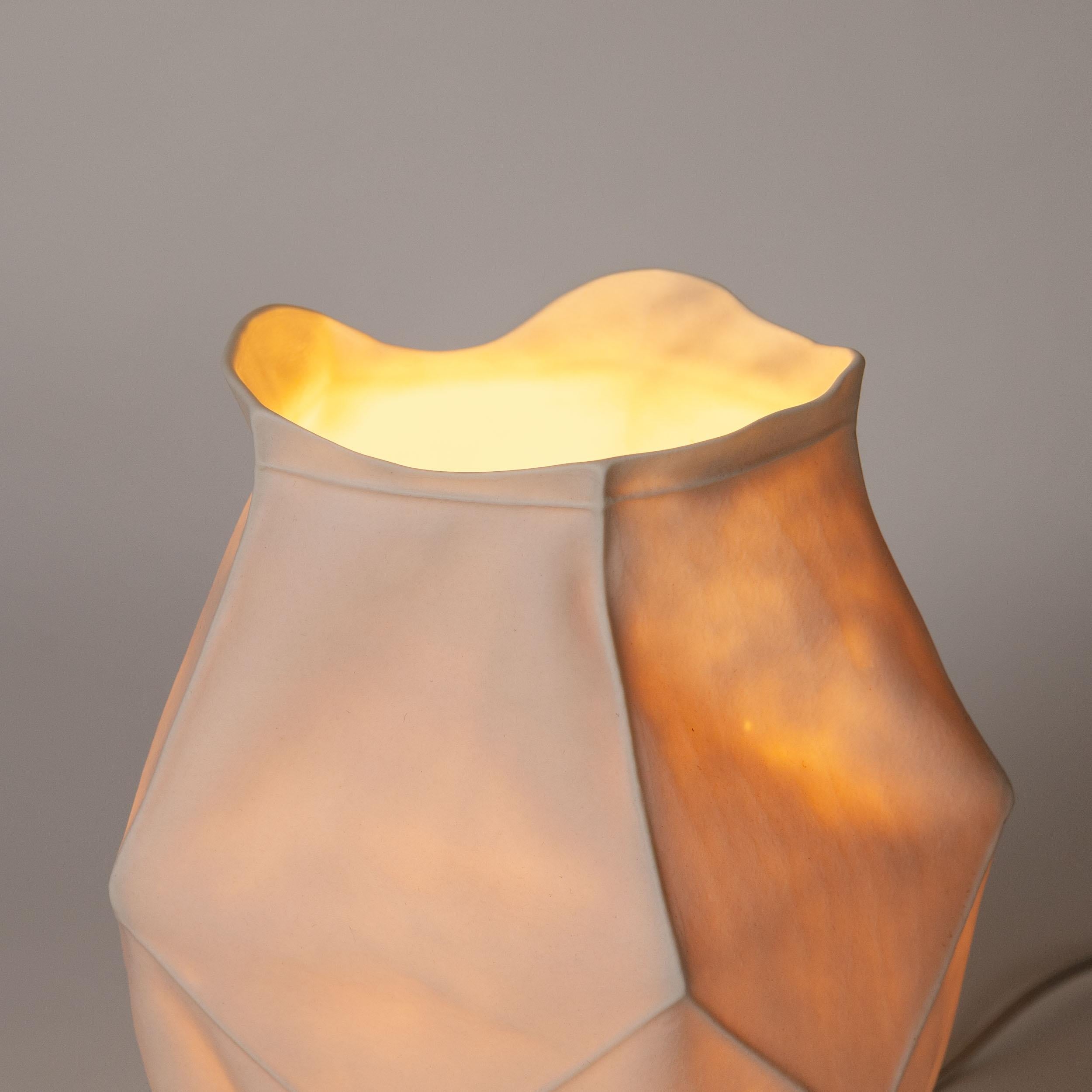 One of a kind Kawa Series Table Lamp by Luft Tanaka Studio

A white ceramic table lamp with a fabric-like organic form produced by casting liquid porcelain into a sewn leather mold. The translucent porcelain body results in the light to cast a warm