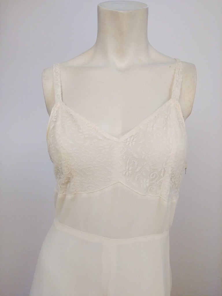 White Lace-Detail Slip Dress, 1930s. Lace overlay to bust, natural waist seam, and full length skirt. 