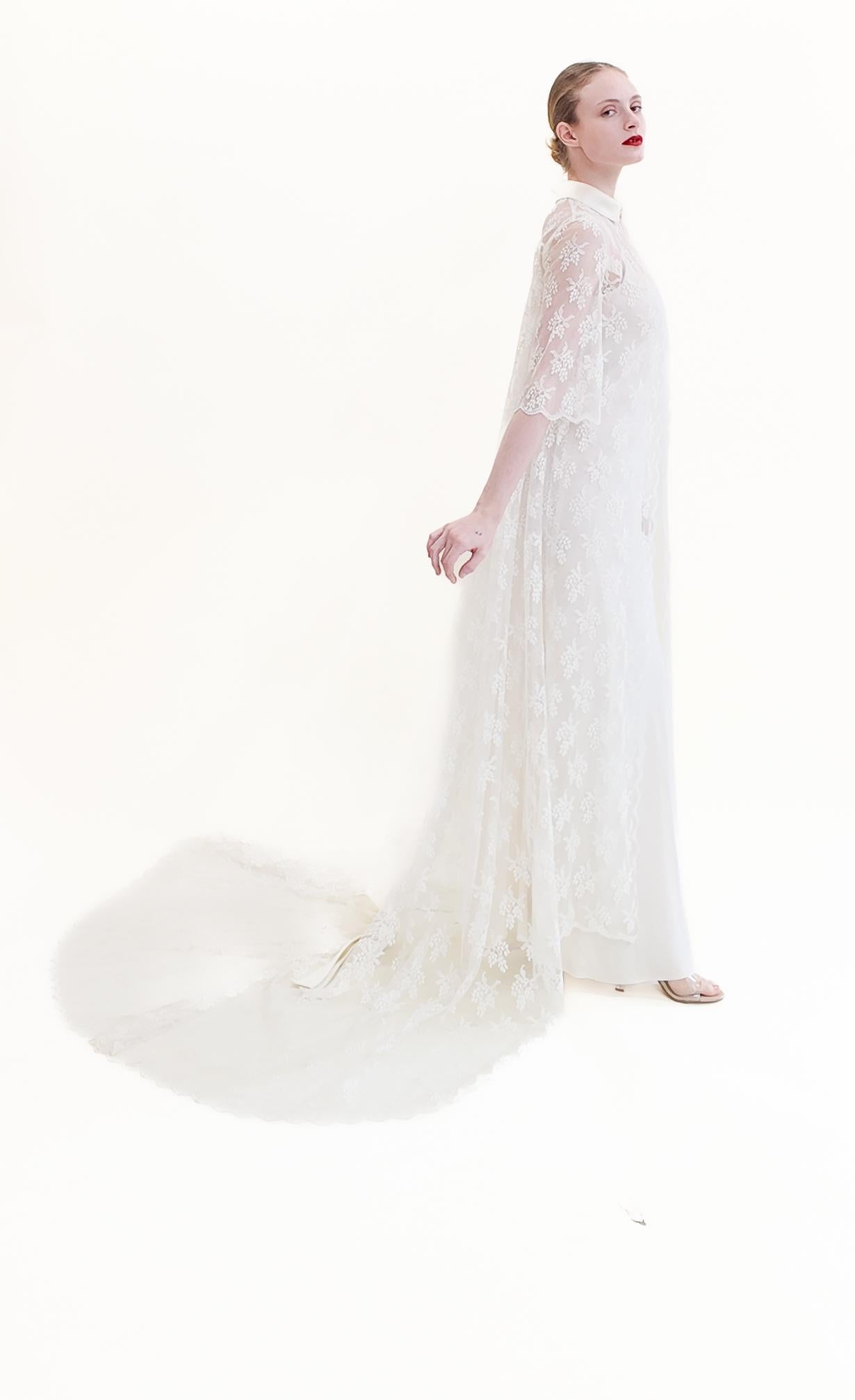 Expertly designed for the perfect bridal look, this White Lace Duster features a satin bow on the back, full lace for a delicate touch, and a long train for an elegant silhouette. The satin collar adds a touch of luxury. A must-have for any